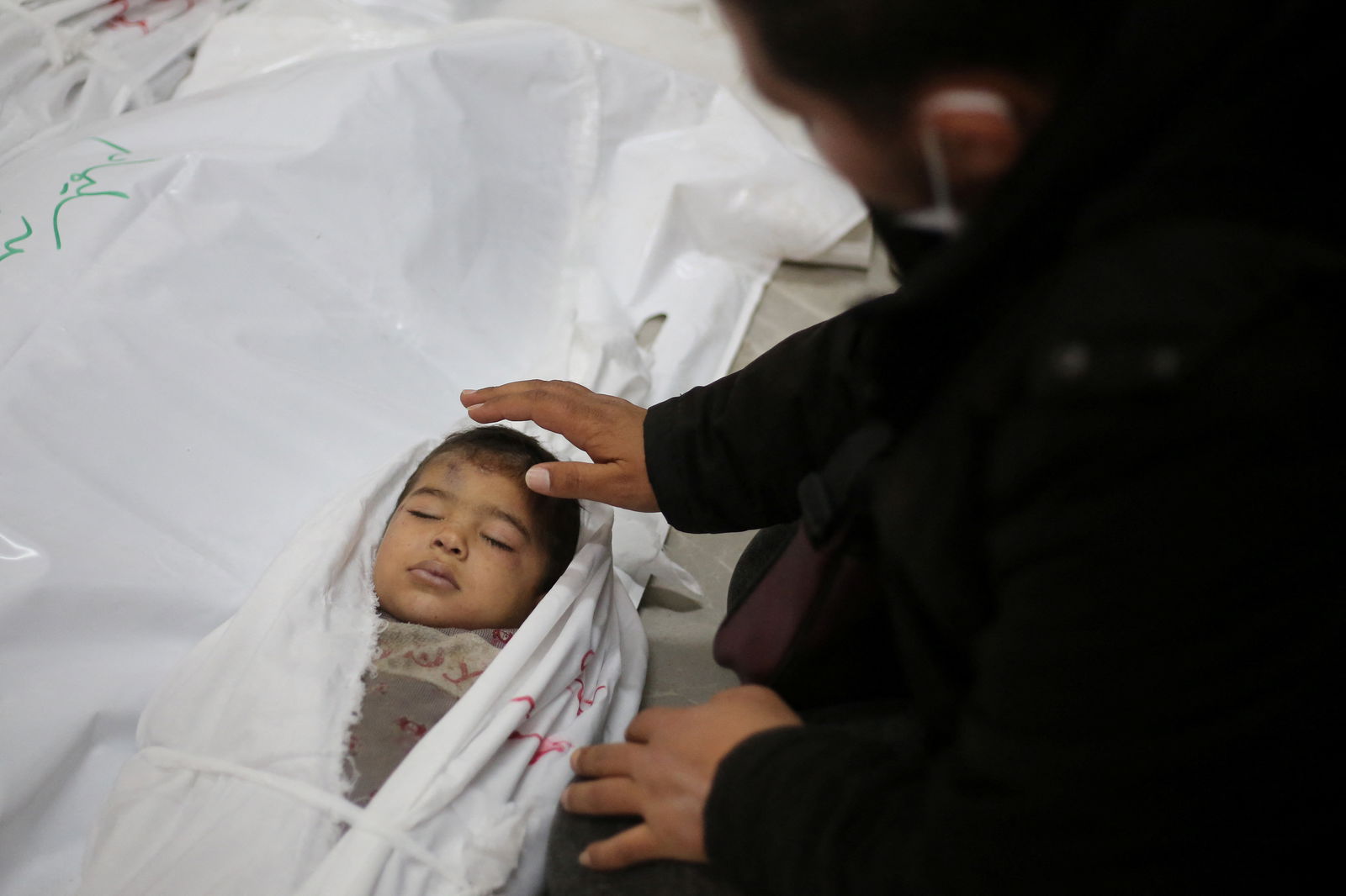 SENSITIVE MATERIAL. THIS IMAGE MAY OFFEND OR DISTURB. A mourner reacts next to the body of a Palestinian child killed in an Israeli strike, amid the ongoing conflict between Israel and Hamas, in Khan Younis in the southern Gaza Strip March 29, 2024. 