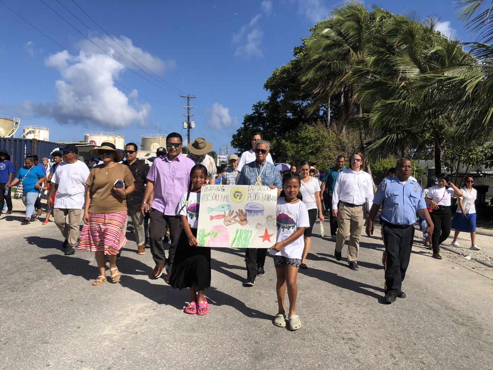 Hundreds of people marched in Majuro, capital of the Marshall Islands, on March 1 to mark the 70th anniversary of the Bravo hydrogen bomb test at Bikini Atoll, including Foreign Minister Kalani Kaneko, left center, and Pacific Islands Forum Secretary General Henry Puna, next to Kaneko.