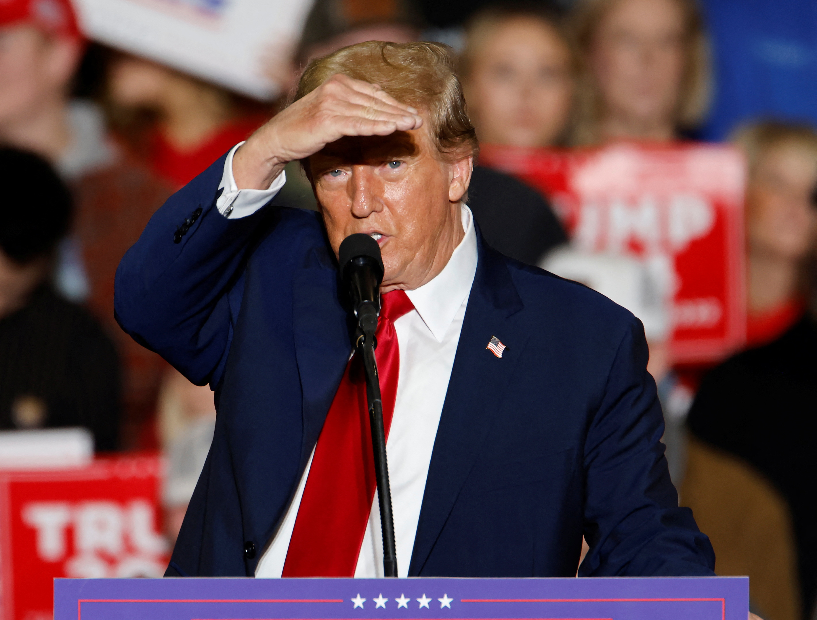 Republican presidential candidate and former U.S. President Donald Trump shields his eyes to see the media while speaking about the press at a rally in Greensboro, North Carolina, U.S., March 2, 2024. 
