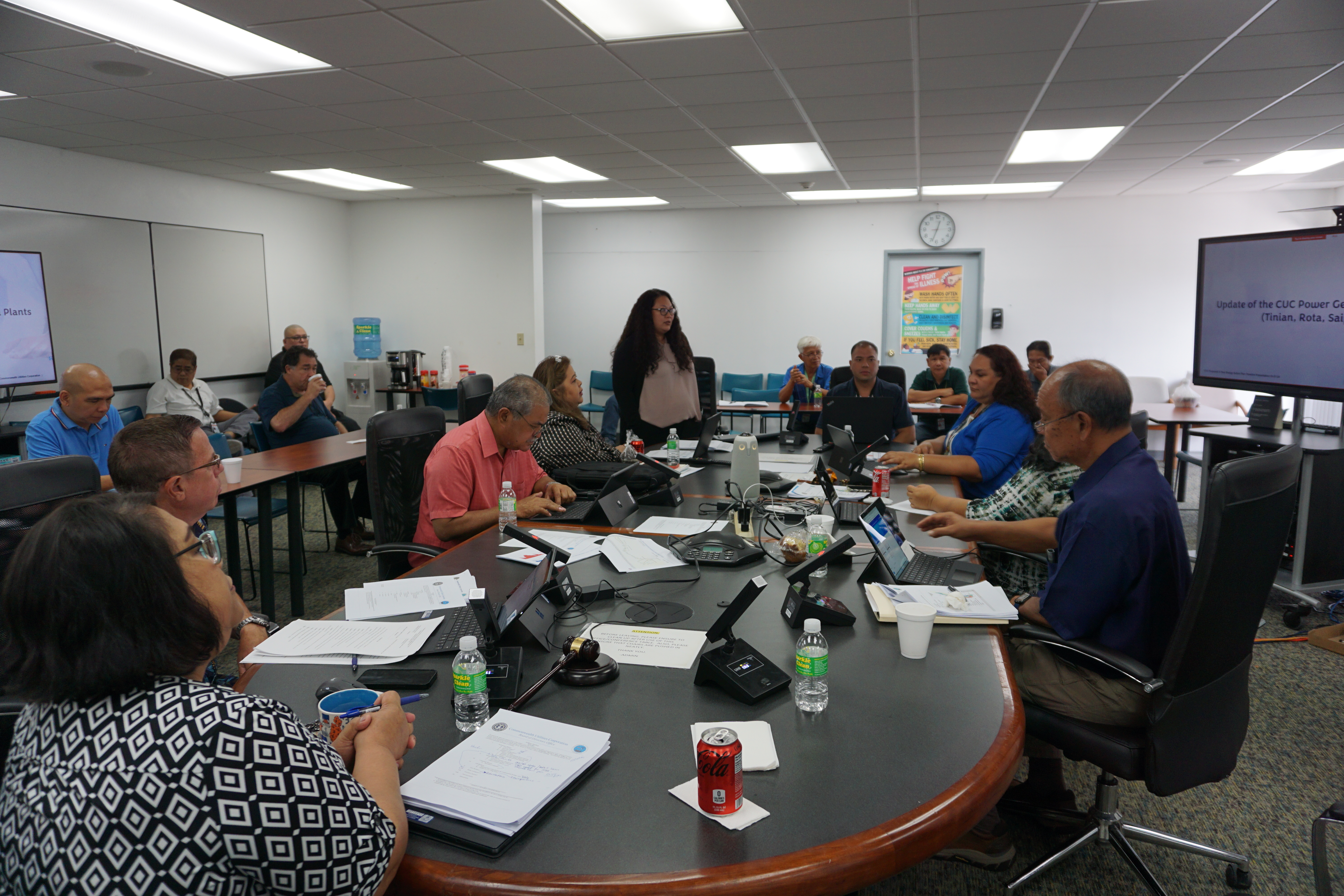 Commonwealth Utilities Corporation engineer Yvonne Ogumuro, standing, presents CUC’s proposed Five-year Energy Action Plan during the CUC board of directors’ regular meeting on Wednesday, March 27. Also in photo are CUC board chair Janice Tenorio, CUC board members Don Browne, Frank Rabauliman, Simon Sanchez, Rebecca White, Valerie Atalig (partially hidden), CUC acting Executive Director Betty Terlaje, and Andrew Reyes CUC renewable energy engineer.