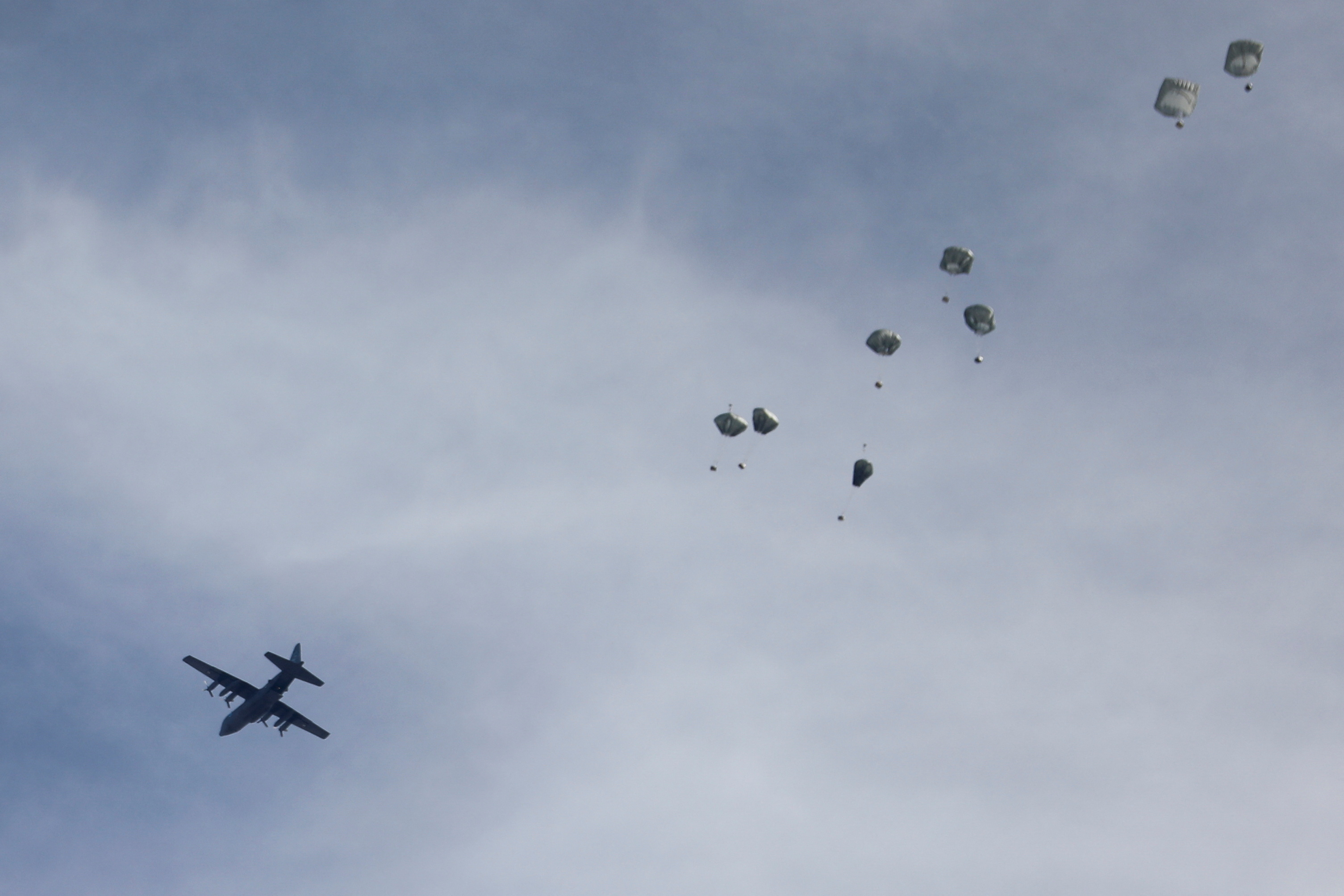 A plane drops aid over Gaza, amid the ongoing the conflict between Israel and Hamas, in Gaza City, March 1, 2024. 