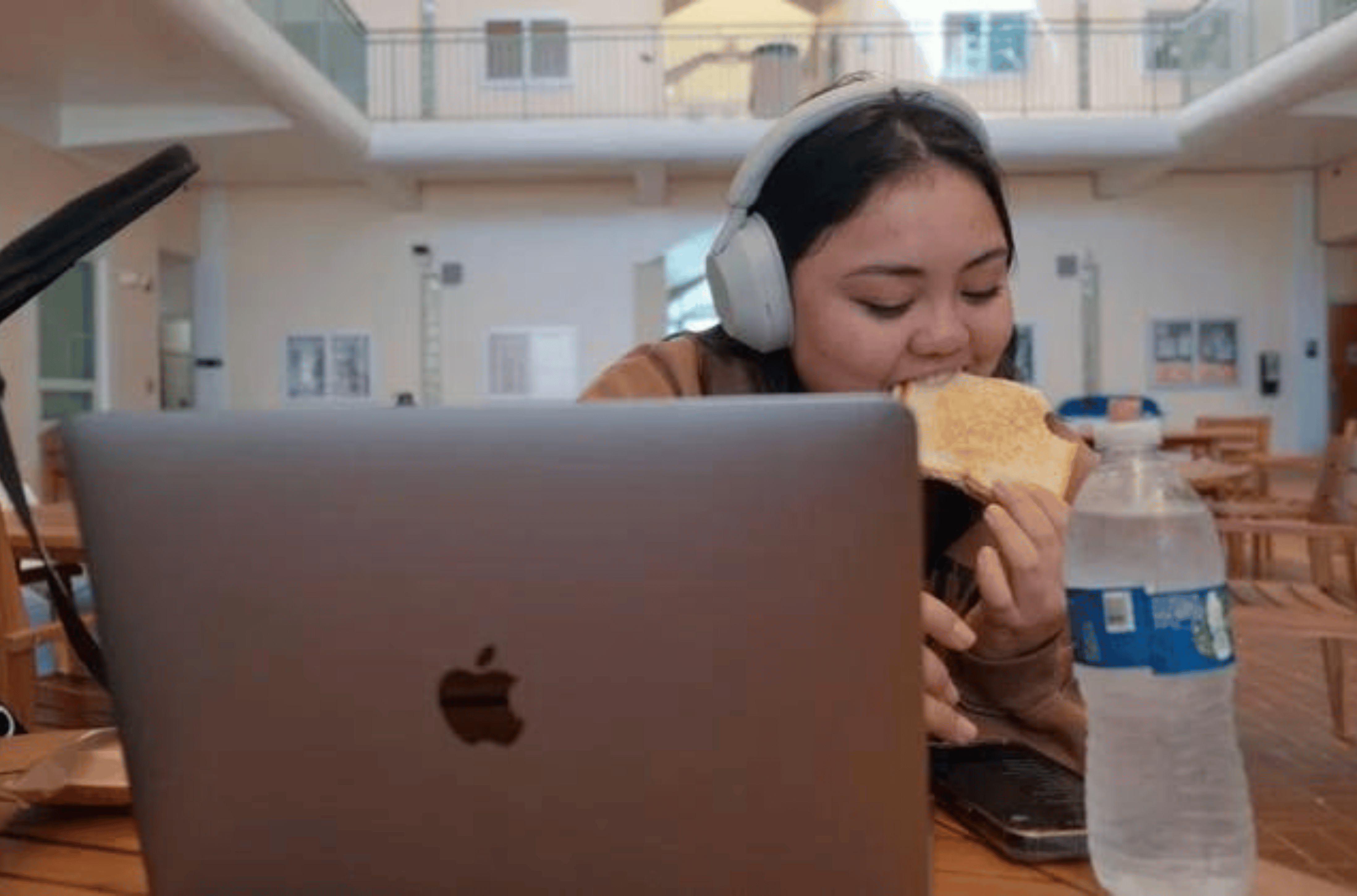 Taijah-Rai Arce, a University of Guam student, uses her phone and laptop in between classes at the Mangilao campus on Thursday, Feb. 22, 2024. 