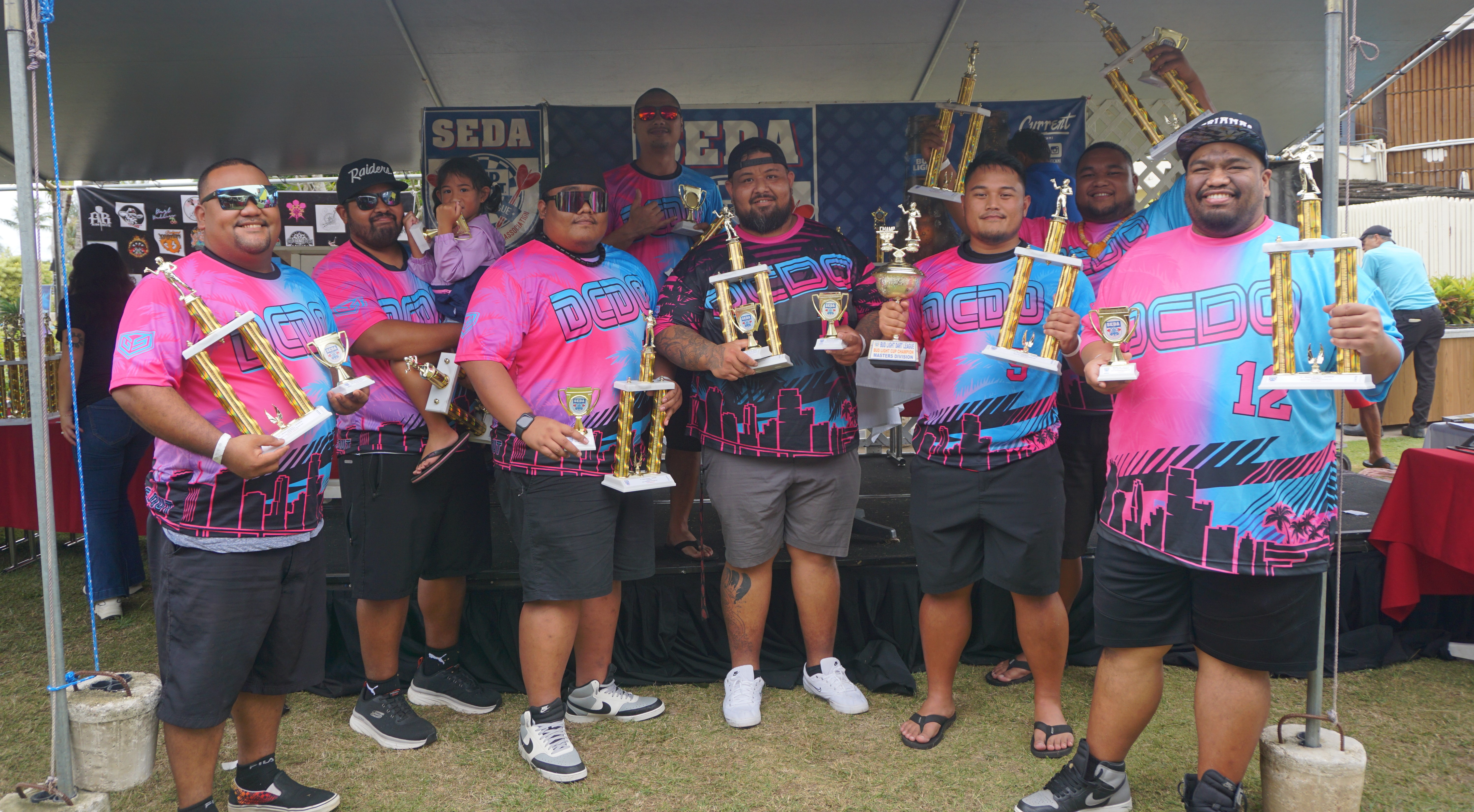 Spicy Thai Double Chin Double Out team members pose with their 1st place trophies and the Bud Light Cup in the Masters Division.