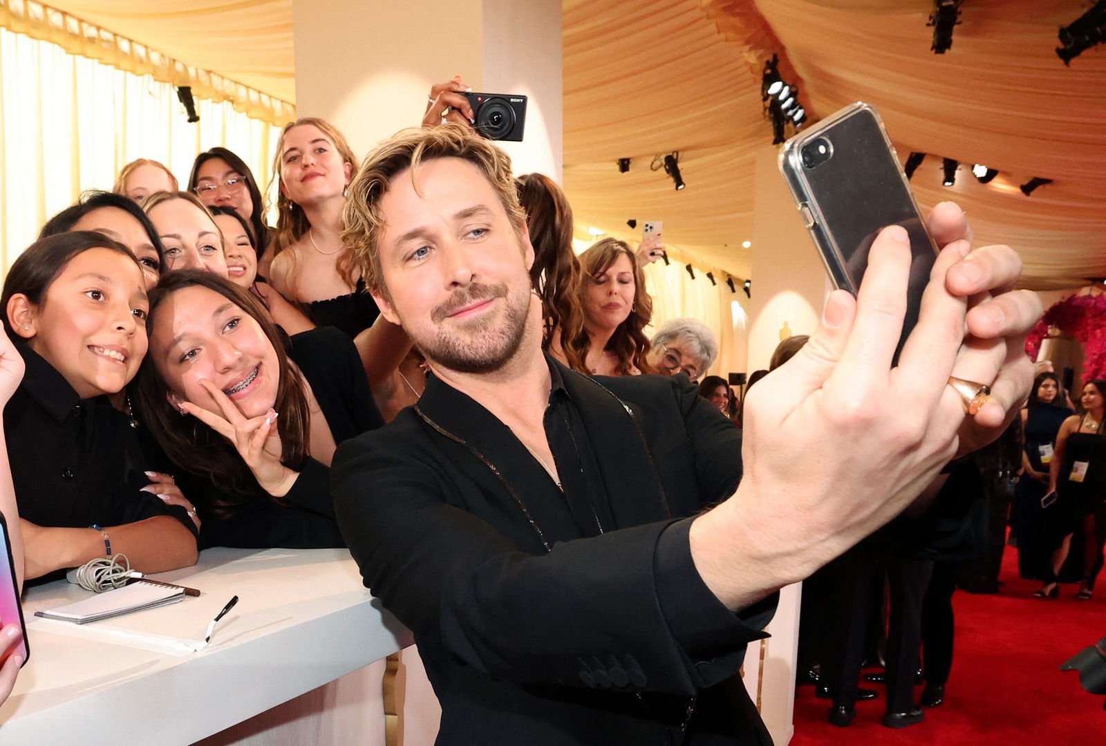 Ryan Gosling poses for a photograph with spectators on the red carpet during the Oscars arrivals at the 96th Academy Awards in Hollywood, Los Angeles, California, U.S., March 10, 2024. 