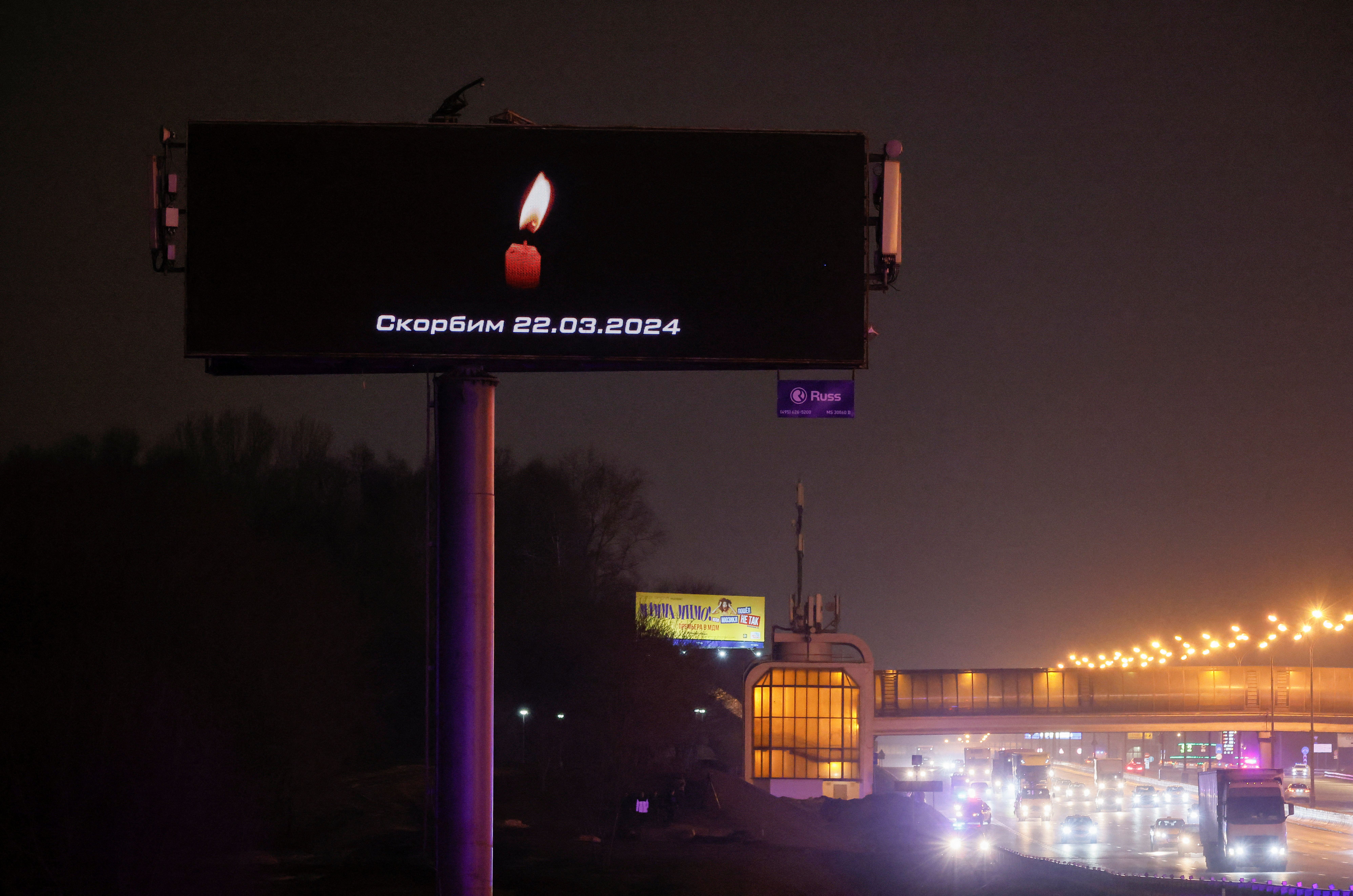 A digital board with a date and a slogan, that reads "We mourn" displayed in memory of victims of the shooting incident, is seen opposite the Crocus City Hall concert venue on the outskirts of Moscow, Russia, March 23, 2024. 
