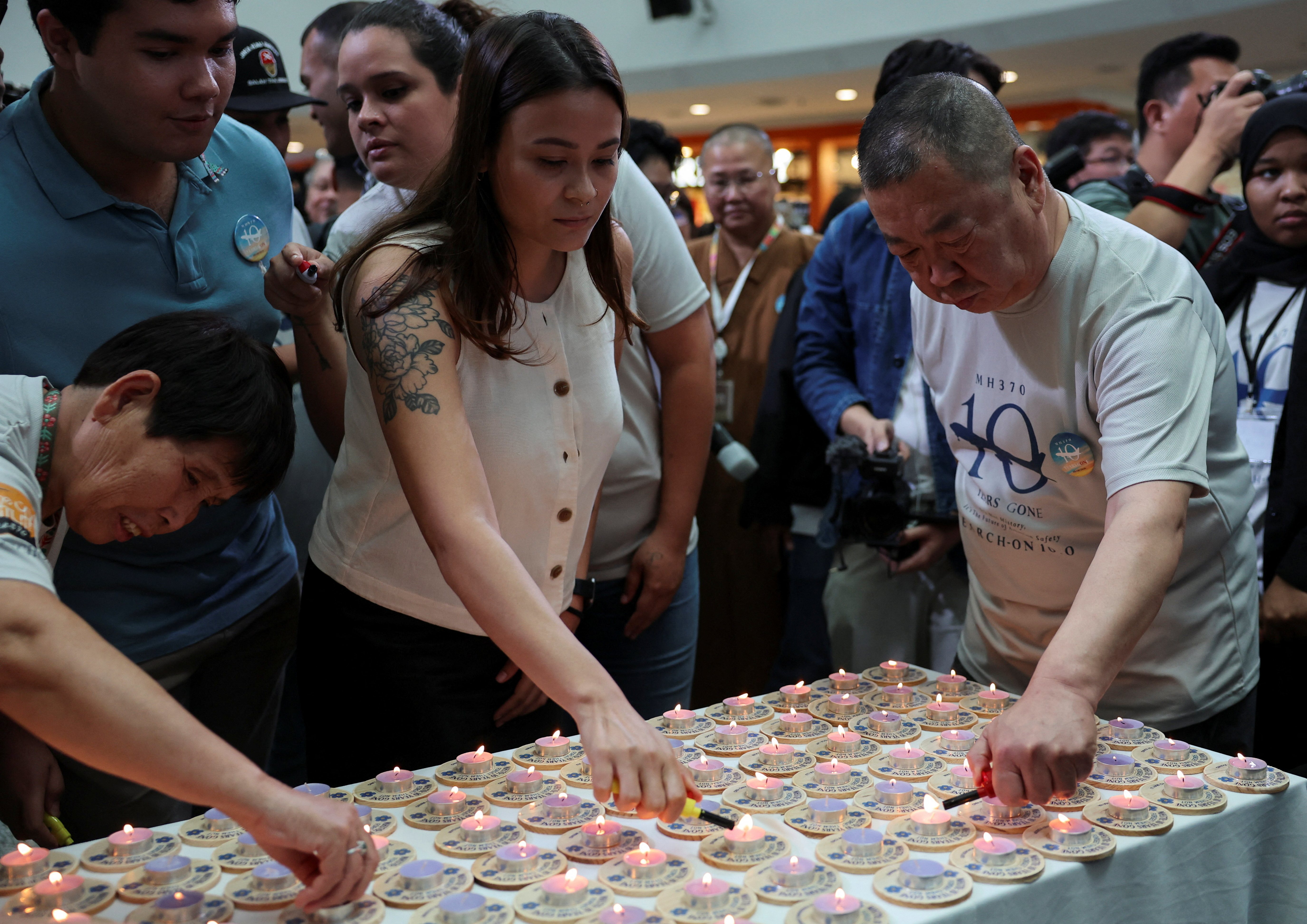Family members of the missing Malaysia Airlines flight MH370 light candles during a remembrance event marking the 10th anniversary of its disappearance, in Subang Jaya, Malaysia March 3, 2024. 