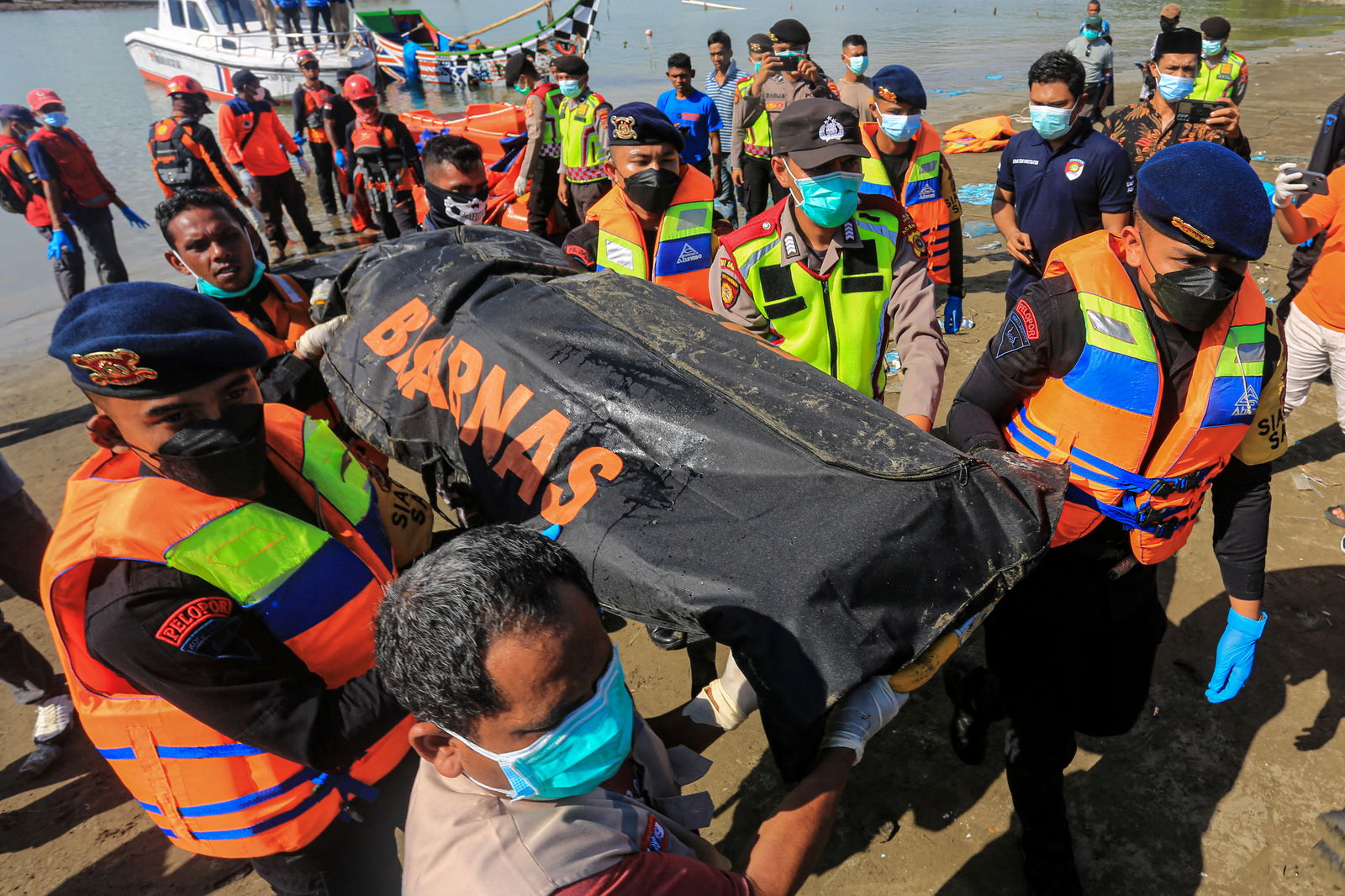 Rescuers carry the body of a Rohingya refugee recovered at sea after the boat they were on capsized off the coast near Calang, Aceh Jaya Regency, Aceh, Indonesia, March 23, 2024, in this photo taken by Antara Foto. 