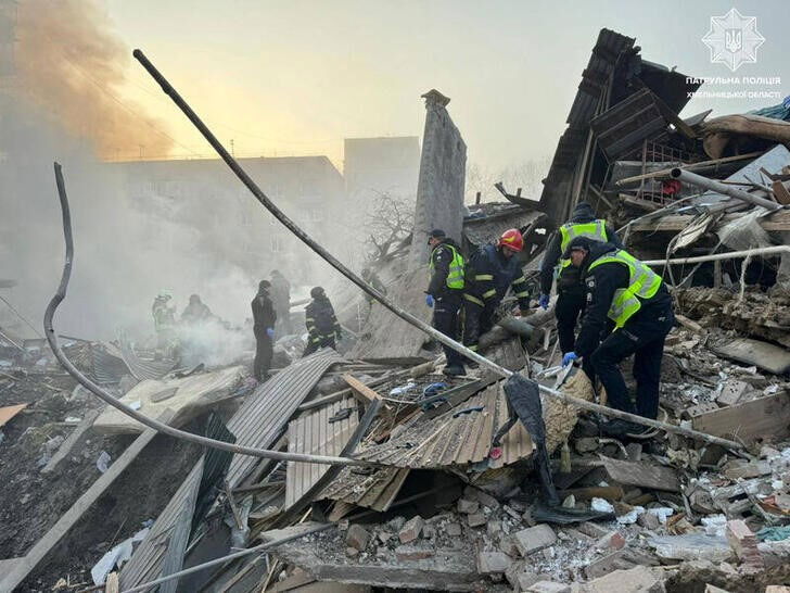 Rescuers and police officers work at a site of residential buildings heavily damaged by a Russian missile strike, amid Russia's attack on Ukraine, in Khmelnytskyi, Ukraine March 22, 2024. S