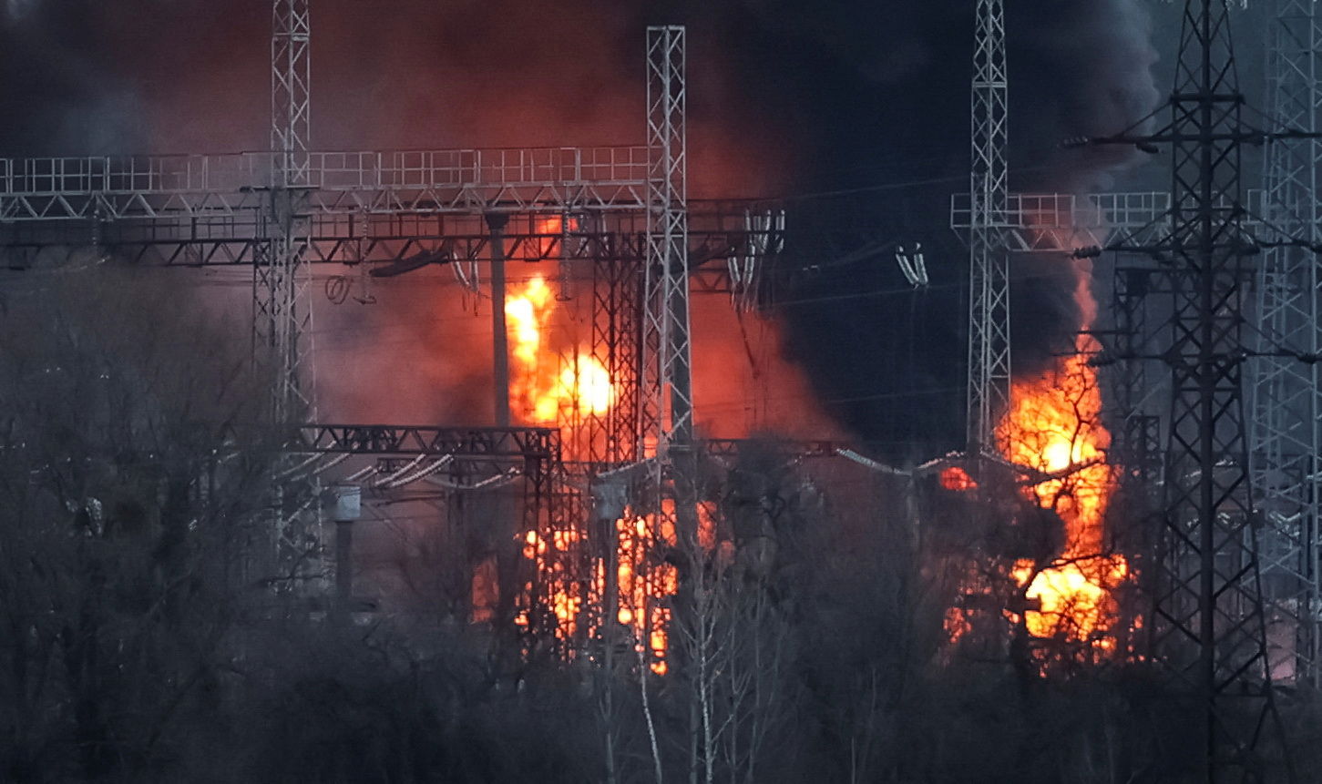 Smoke and fire are seen around high-voltage lines at a site of a Russian missile strike, amid Russia's attack on Ukraine, outside Kharkiv, Ukraine March 22, 2024. 