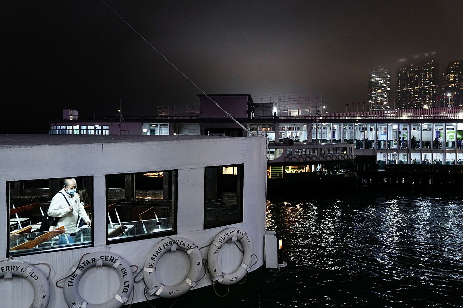 A passenger rides a Star Ferry vessel at night, in Hong Kong, China February 10, 2023. 