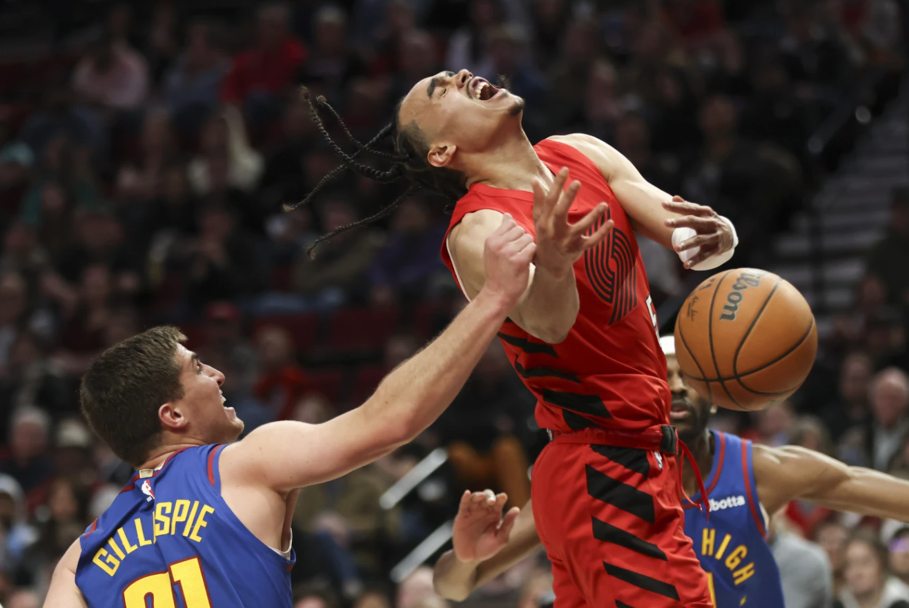 Portland Trail Blazers guard Dalano Banton, right, is fouled by Denver Nuggets guard Collin Gillespie during the second half of an NBA game Saturday, March 23, 2024 in Portland, Ore.