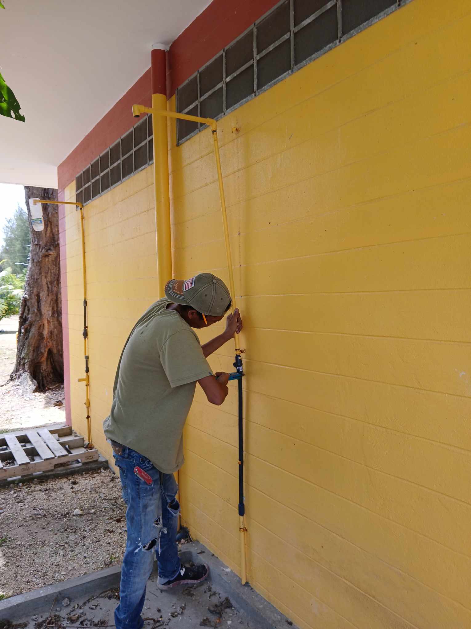 A worker fixes the broken water pipe of the public restroom at Laly 4 on Thursday afternoon.
