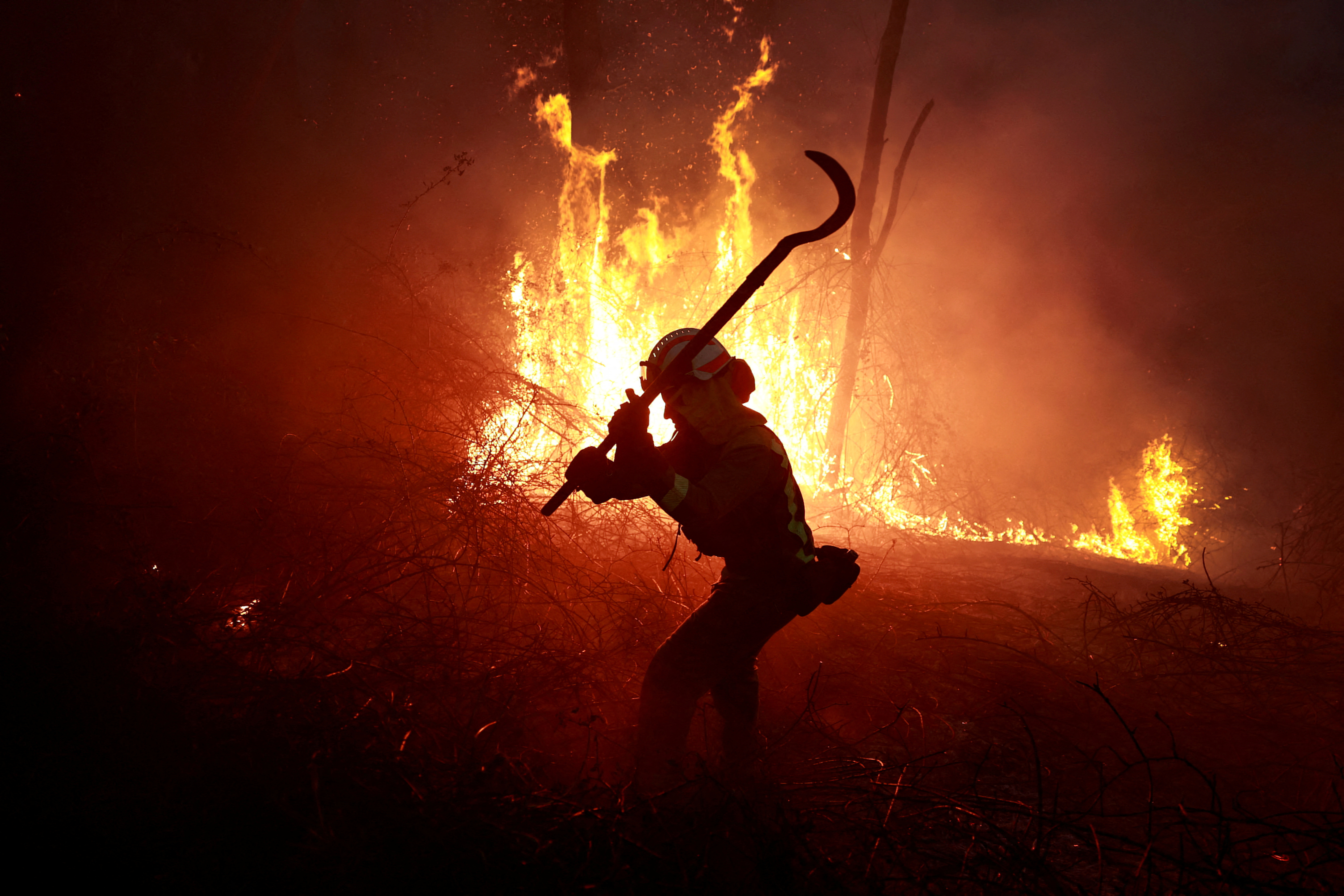 A firefighter from Galicia tackles a forest blaze during an outbreak of wildfires, following a prolonged dry spell and unseasonably high temperatures, in Peidrafita, Asturias, Spain, March 31, 2023. 