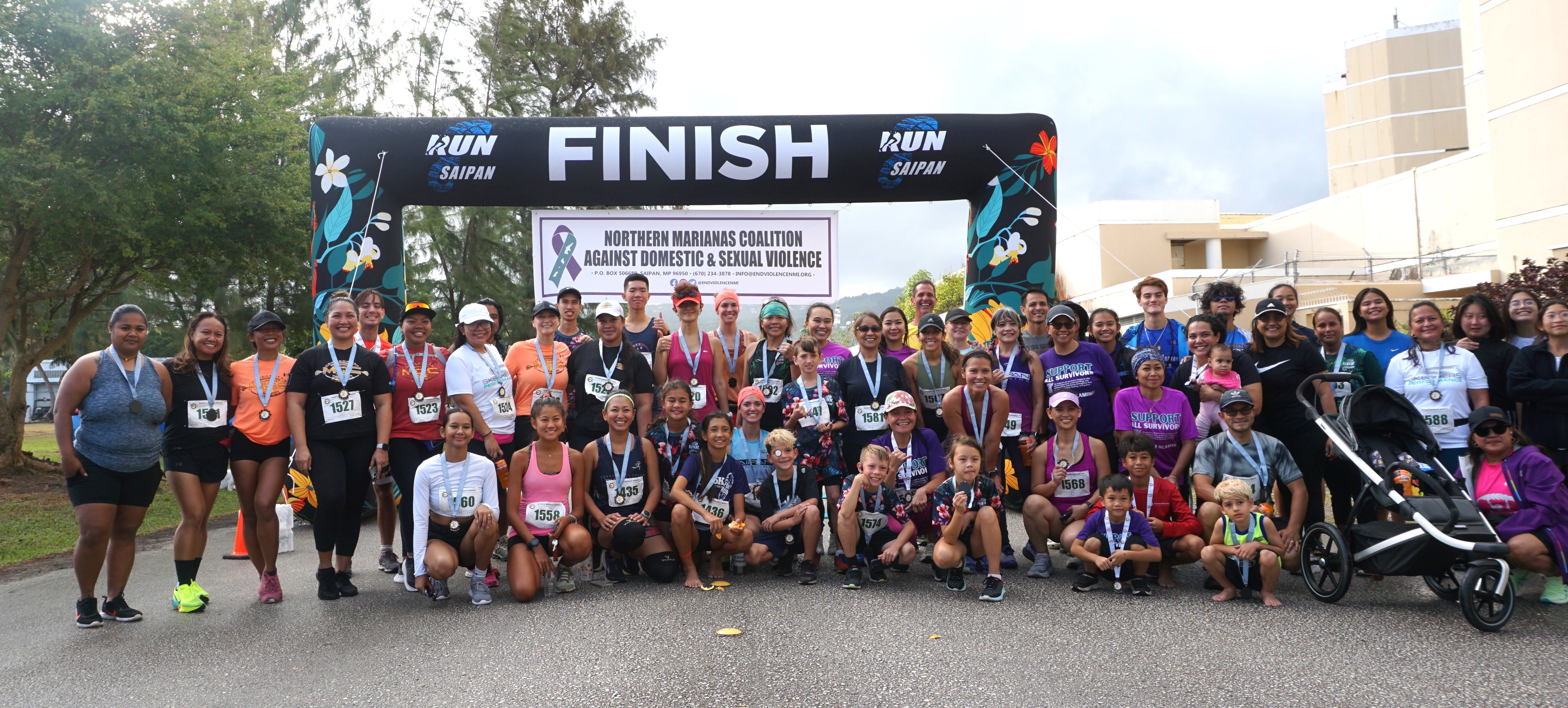 The participants of the 4th 10KM NMI Women's Run pose for a group photo at Micro Beach on Saturday.
