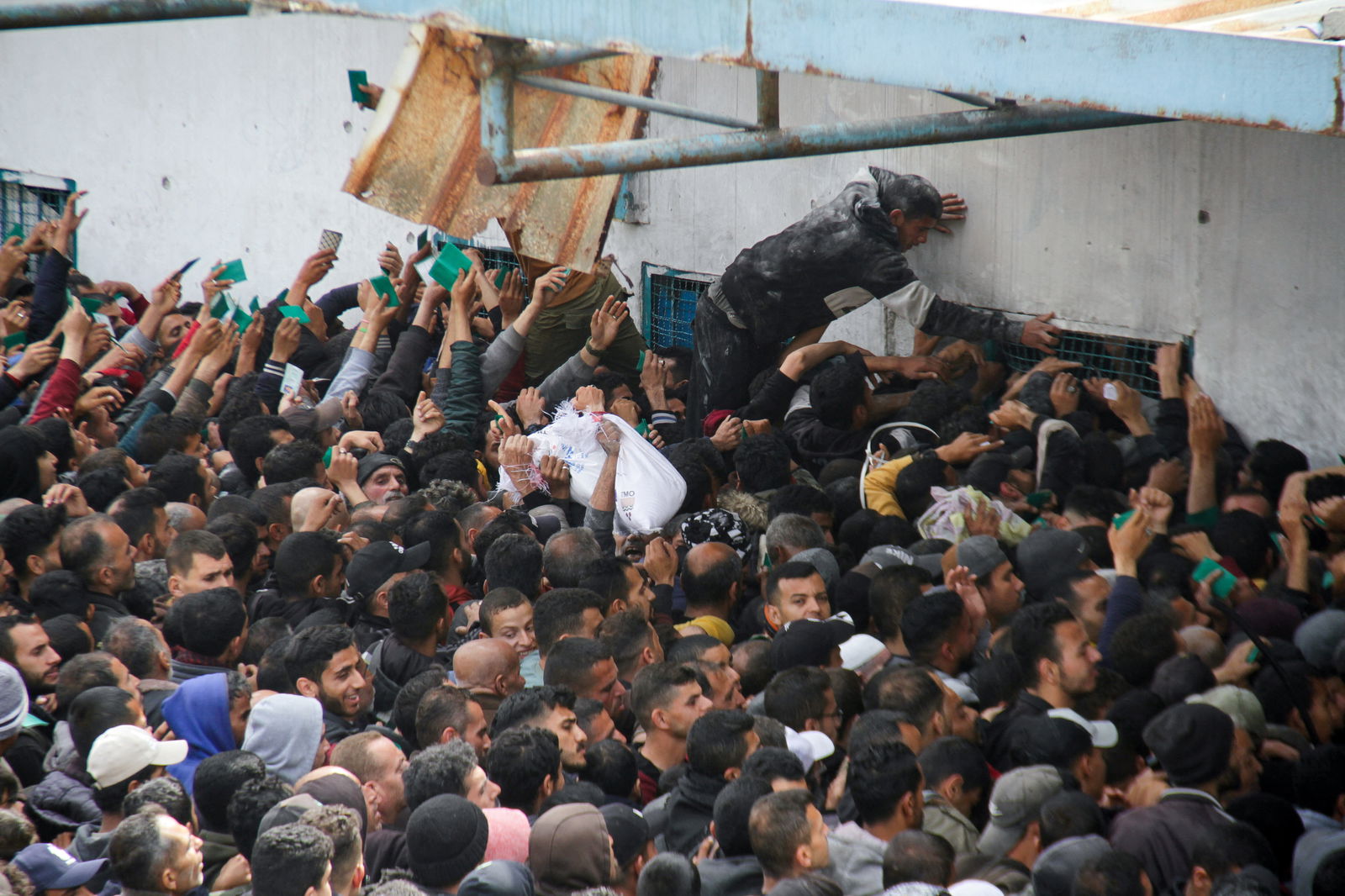 Palestinians gather to receive aid in Gaza City. 