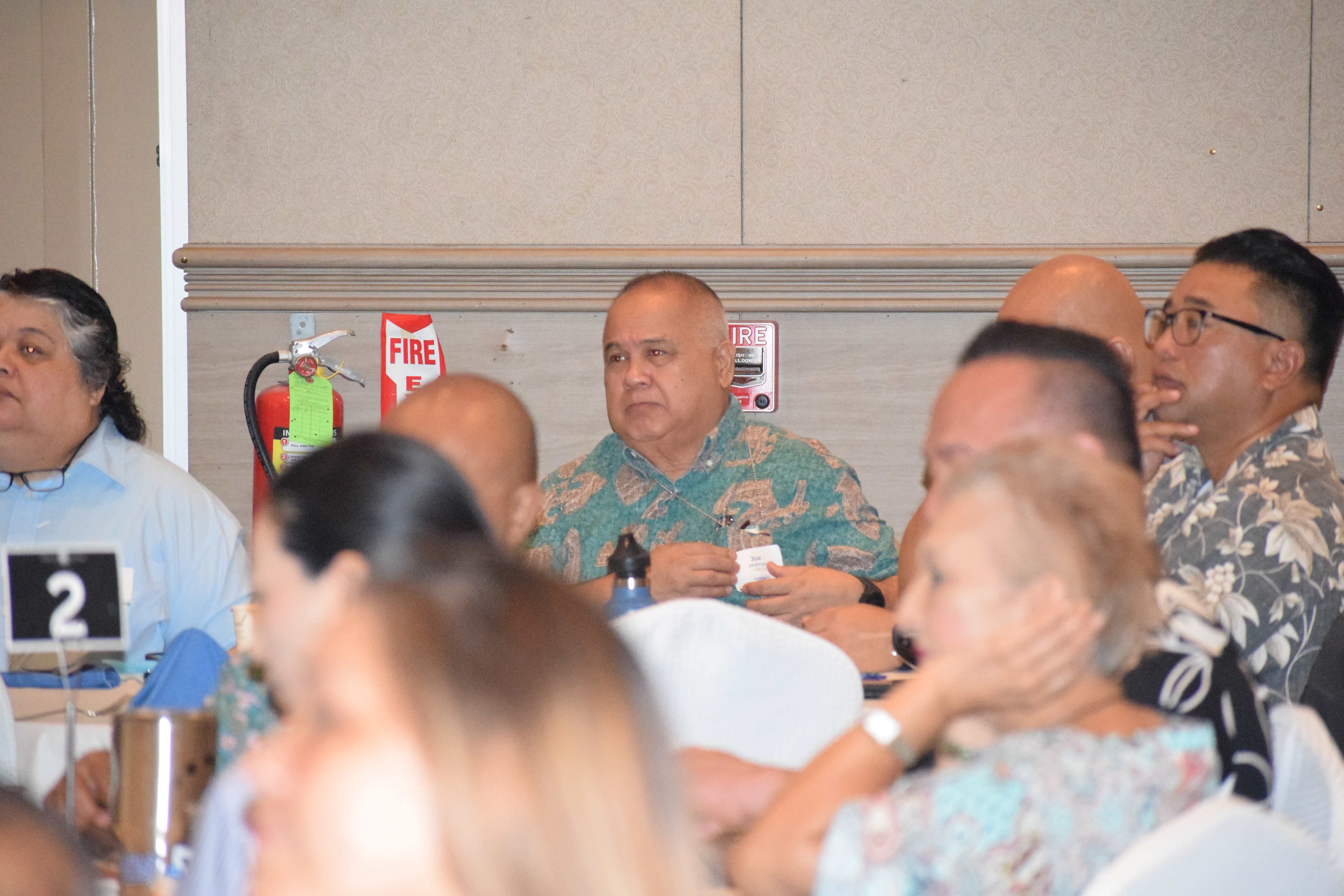 Customs and Biosecurity Director Jose Mafnas, center, listens to Gov. Arnold I. Palacios' remarks.