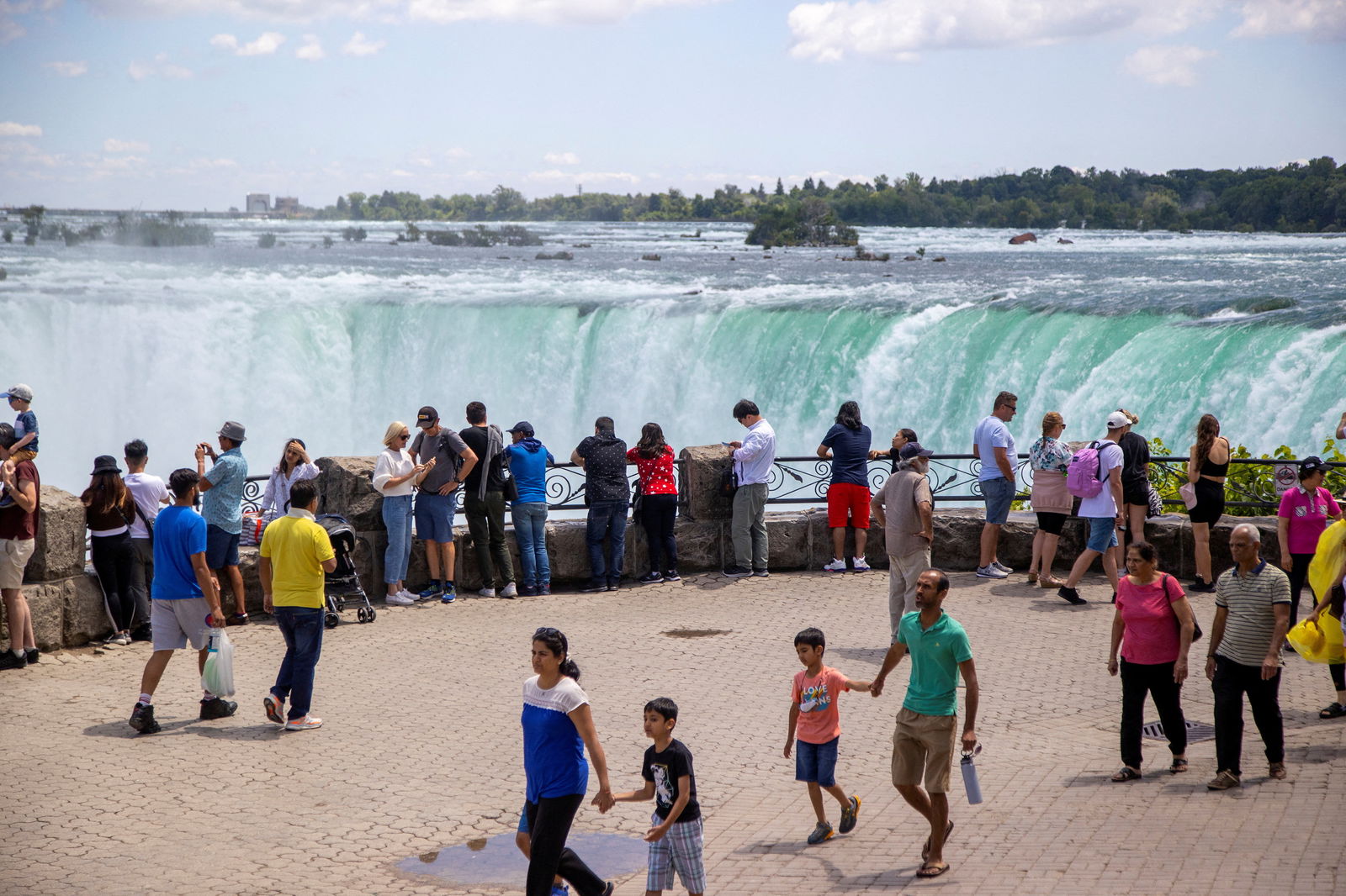 FILE PHOTO: Tourist take photos in front of Niagara Falls in Niagara Falls, Ontario, Canada June 28, 2022. 