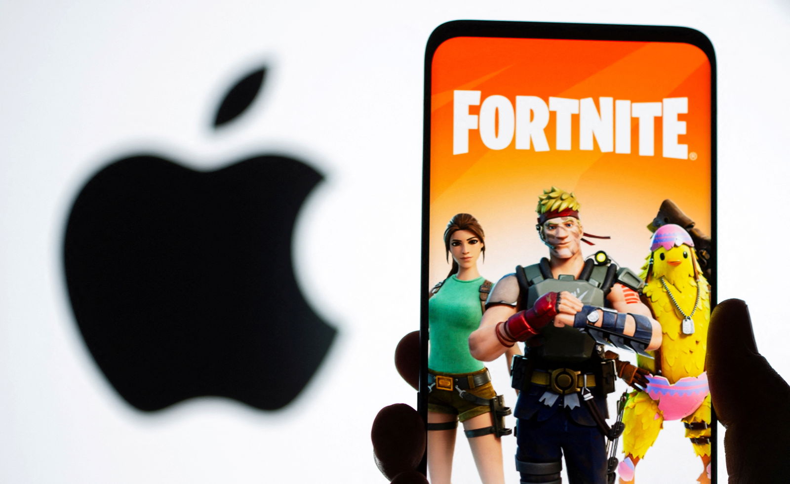 FILE PHOTO: Fortnite game graphic is displayed on a smartphone in front of Apple logo in this illustration taken May 2, 2021. 