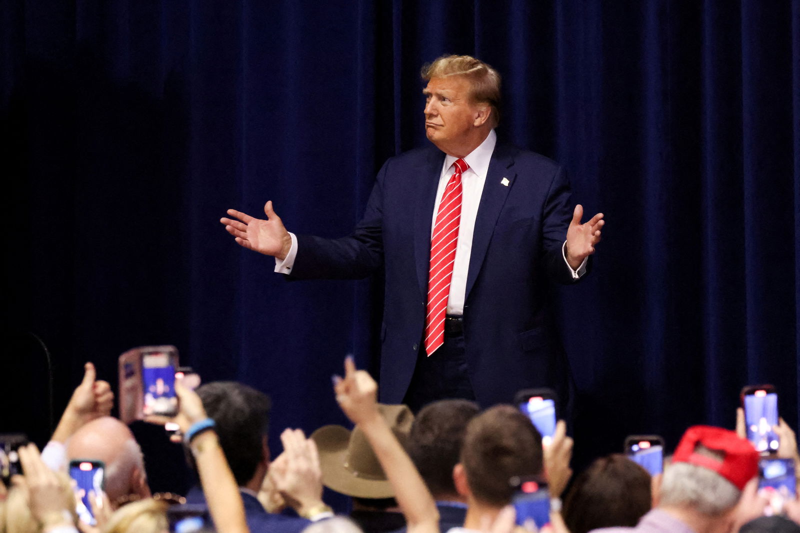 FILE PHOTO: Republican presidential candidate and former U.S. President Donald Trump gestures as he hosts a campaign rally at the Forum River Center in Rome, Georgia, U.S. March 9, 2024. 