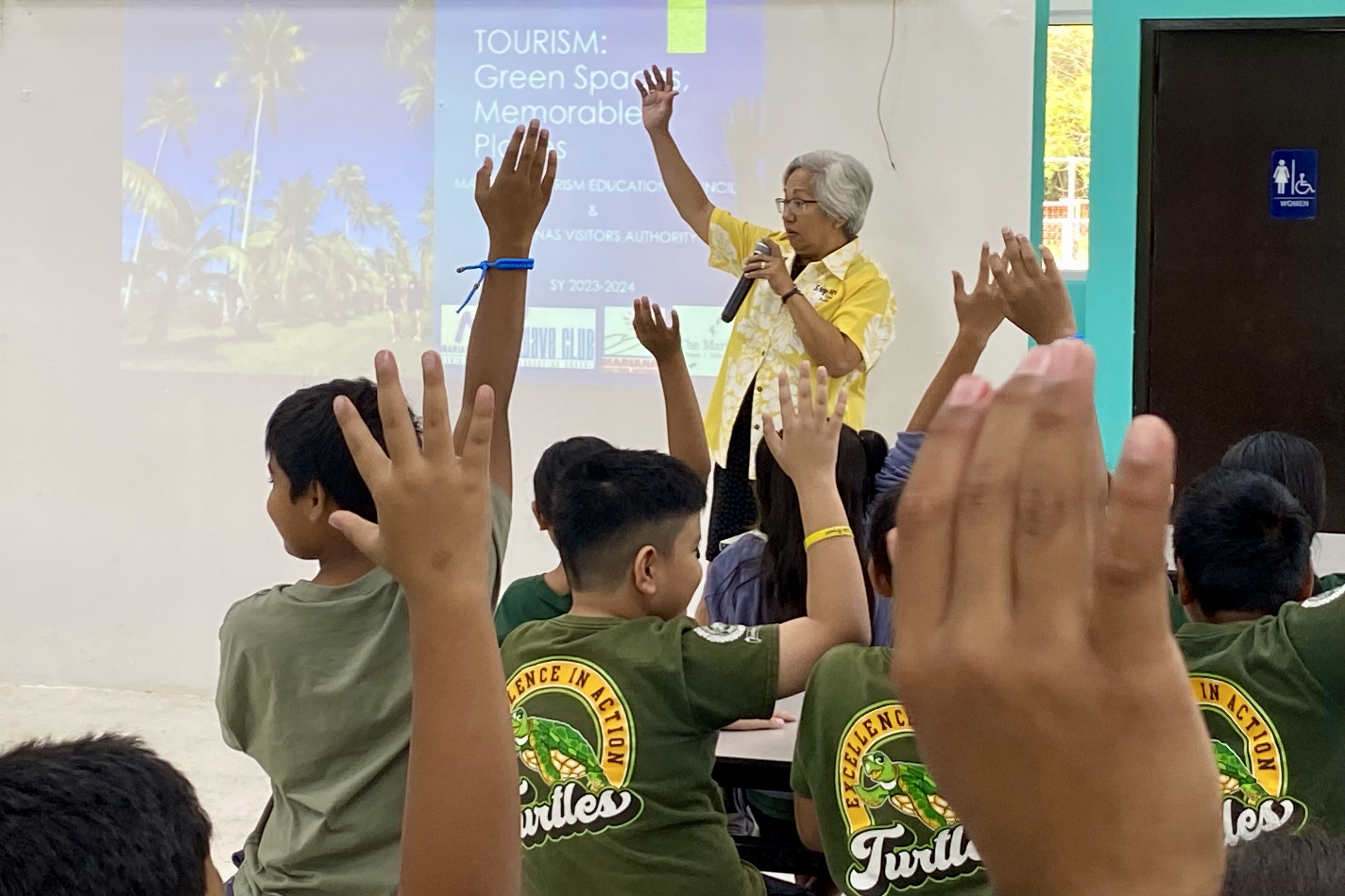 Marianas Tourism Education Council Chairwoman Vicky Benavente engages 4th graders of Oleai Elementary during the educational outreach presentation of MTEC and the Marianas Visitors Authority on March 6, 2024, at the school.