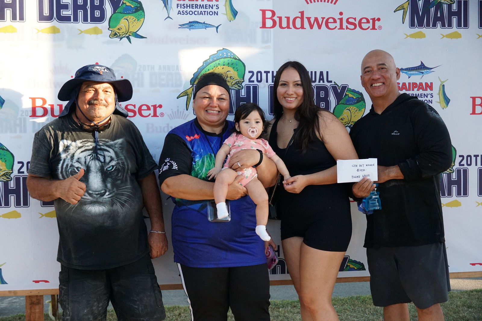 The crewmembers of Betty Ann pose with their wahoo side bet winnings at the conclusion of the 20th Mahi Mahi Fishing Derby at the Smiling Cove Marina on Saturday.