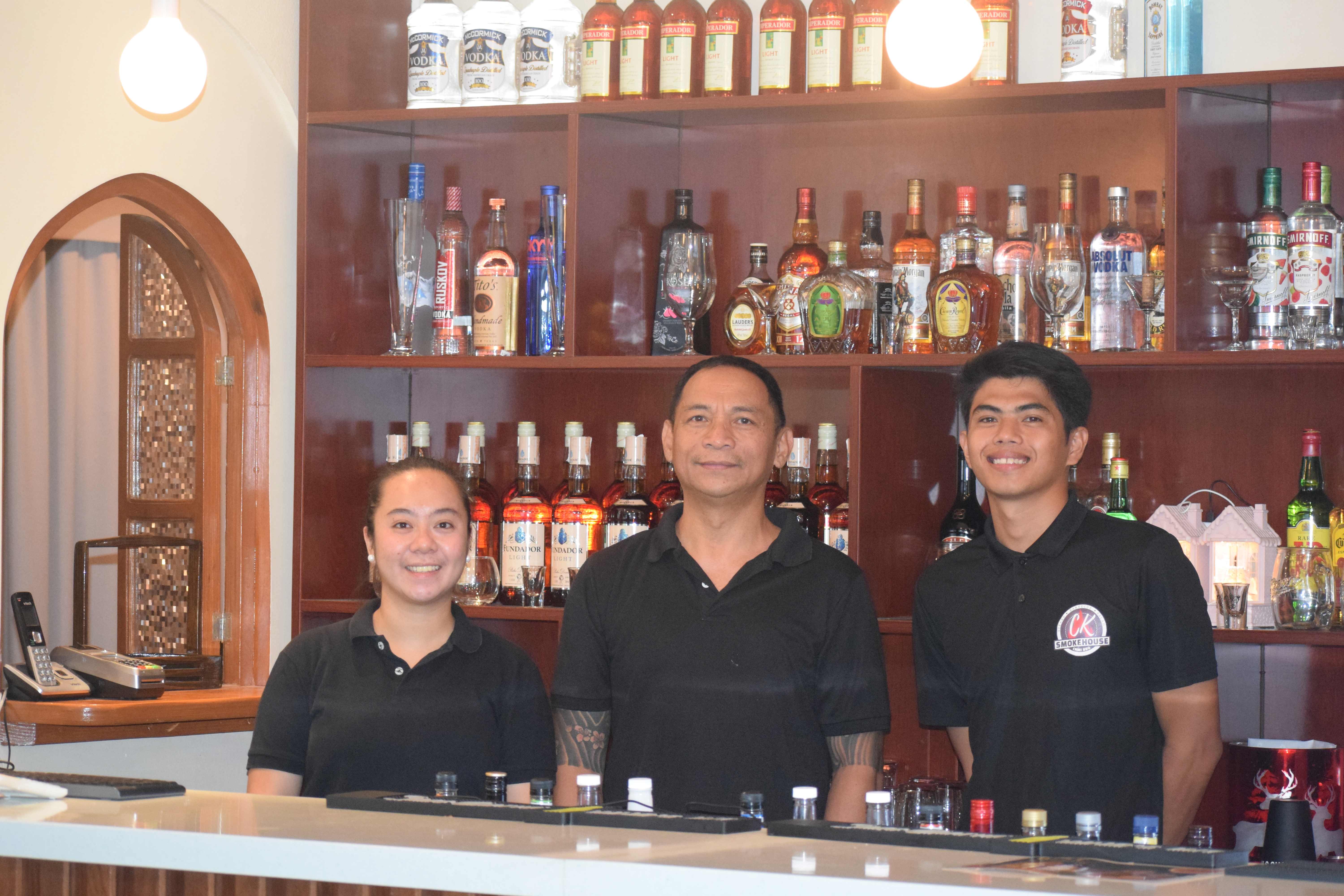 Chicken & Beer's Andrew Estepa, center, with fellow service crewmembers Mariz Sabado, left, and Ivan Banayos.