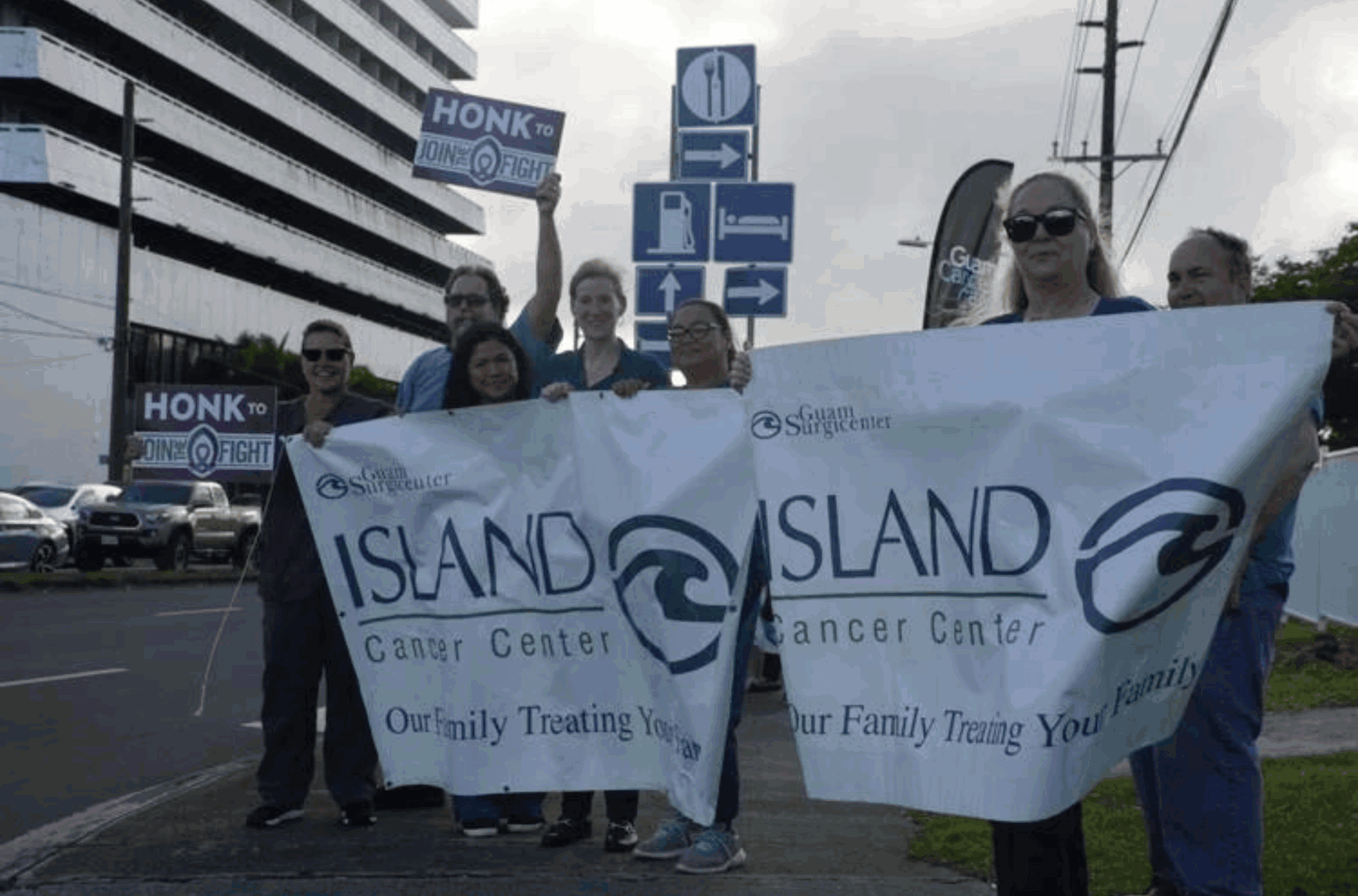 Staff from Island Cancer Center participate in a wave at the ITC intersection on Jan. 20, 2023, in Tamuning. 