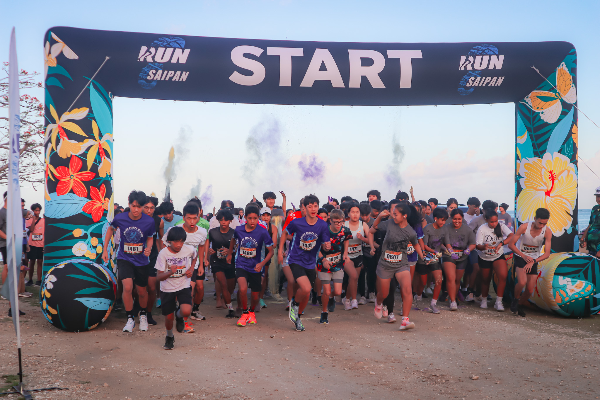 The participants take off as colored powder fills the air during the Dolphin 5.5K Pathway Color Run at the Garapan Fishing Base on Saturday morning.