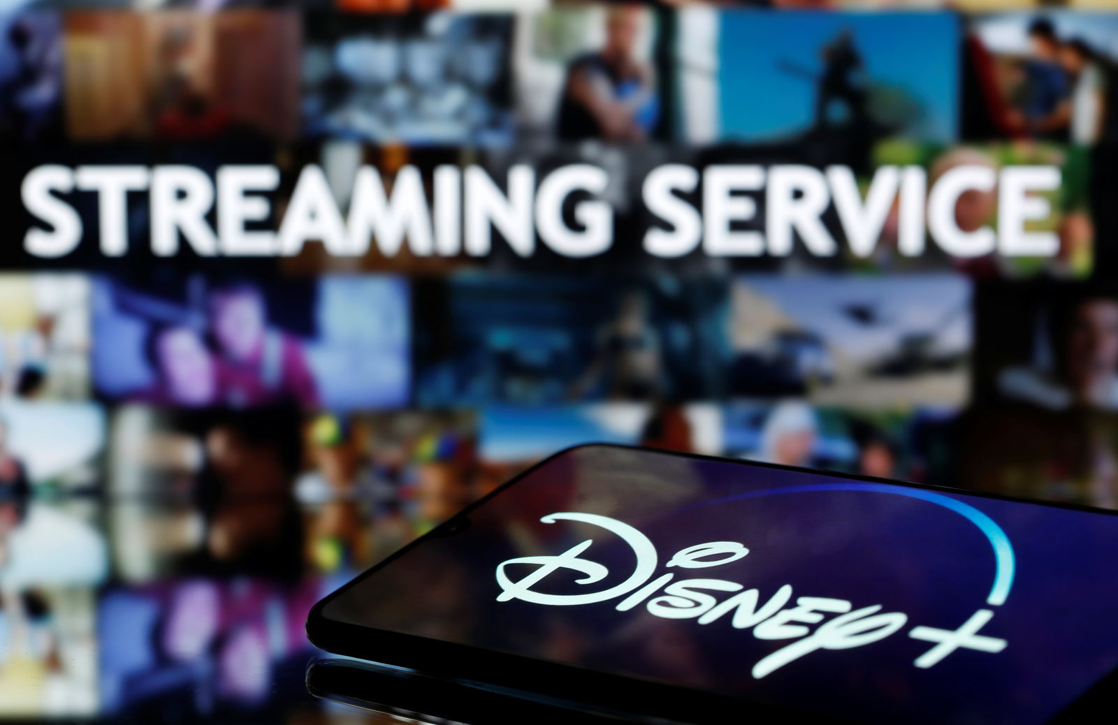 File photo: A martphone with displayed "Disney" logo is seen in front of displayed "Streaming service" words in this illustration taken March 24, 2020. 