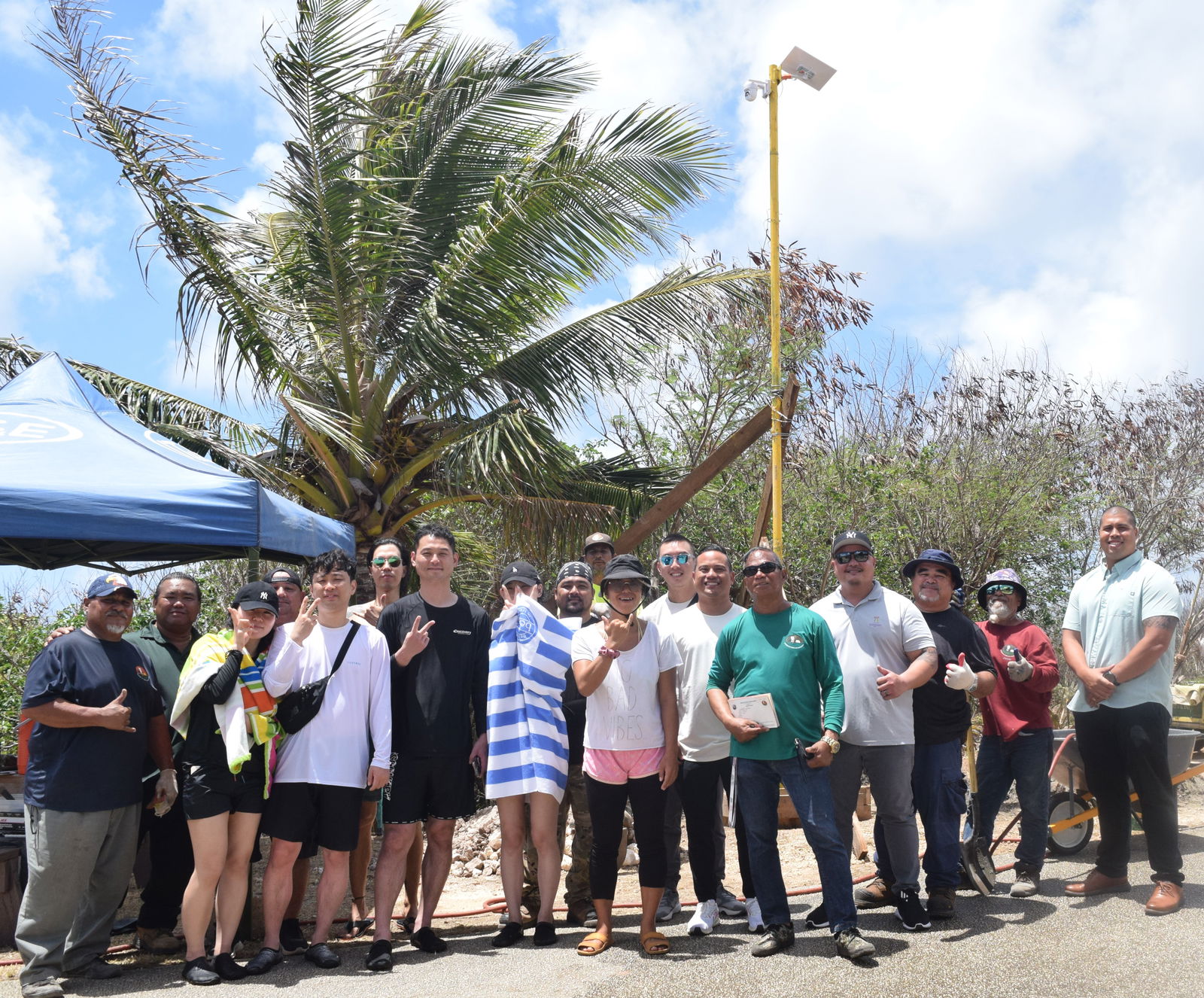 Rep. Angelo Camacho, Parks and Recreation Director Mike Cruz, Park Ranger Max Aguon, Turnkey Solutions managing directors Billy Grow, Broc Calvo and Jerry Lin pose for a photo with tourists in the Grotto parking lot on Friday.