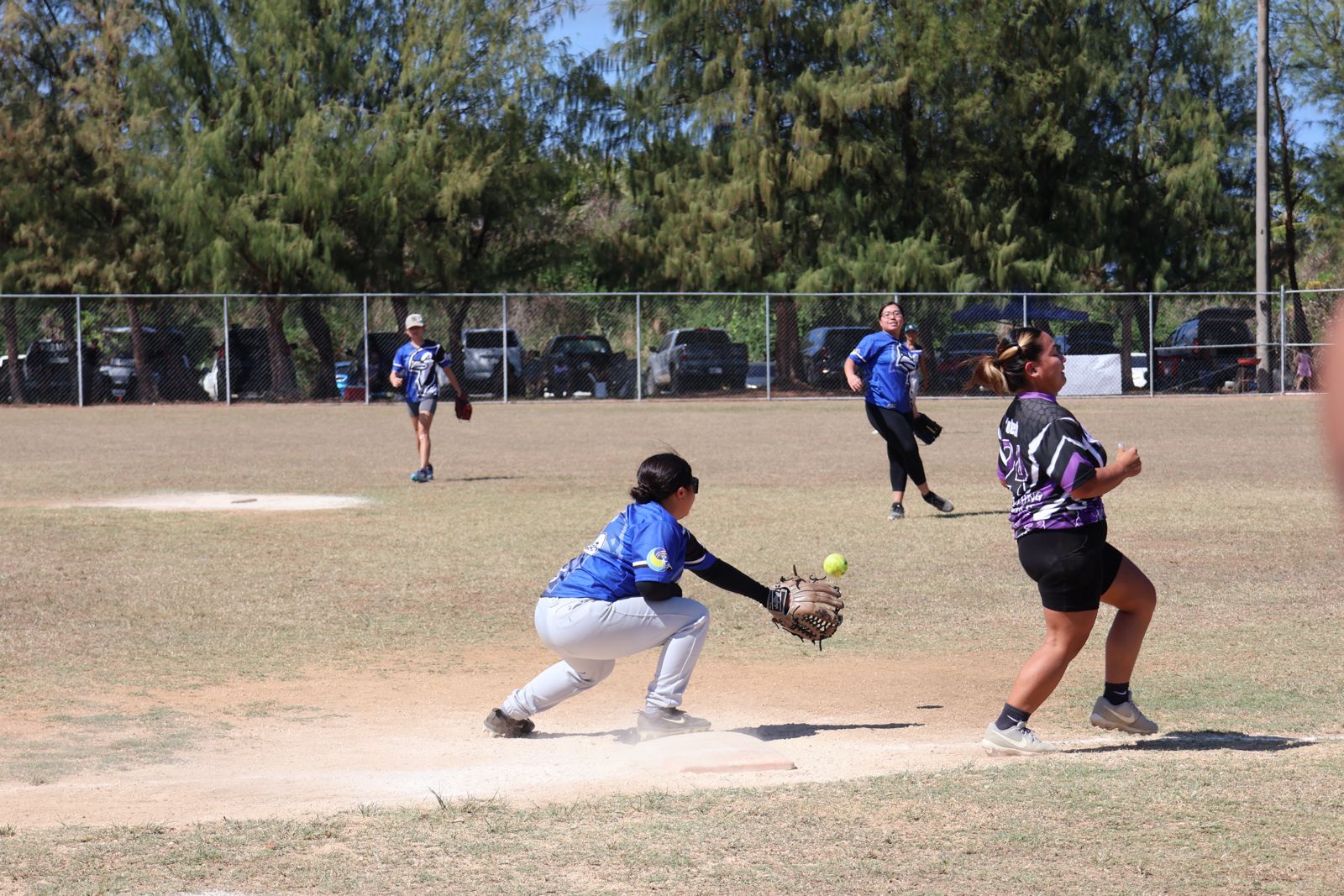 Lady Blue Jays second baseman Carey Demapan throws to first baseman Keolani Rios to pick off a runner during game 1 in the ladies division championship series of the 2024 Budweiser Belau Amateur Softball Association League at the Dandan baseball field on Sunday.