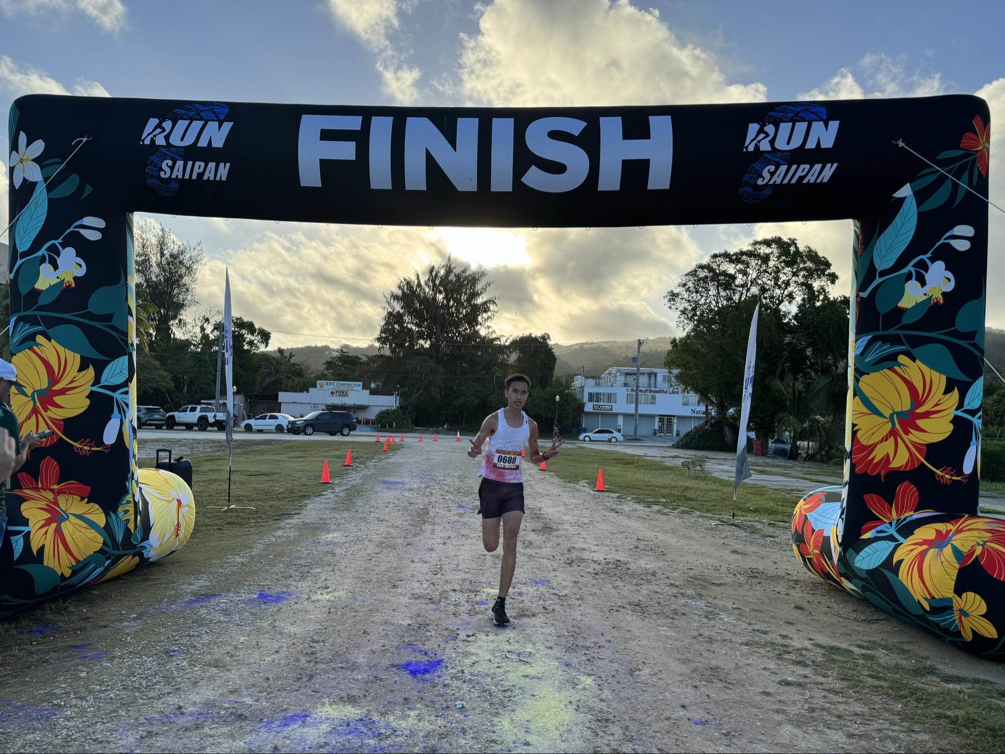 Sildrey Veloria crosses the finish line of the Dolphin 5.5K Pathway Color Run at the Garapan Fishing Base on Saturday morning.