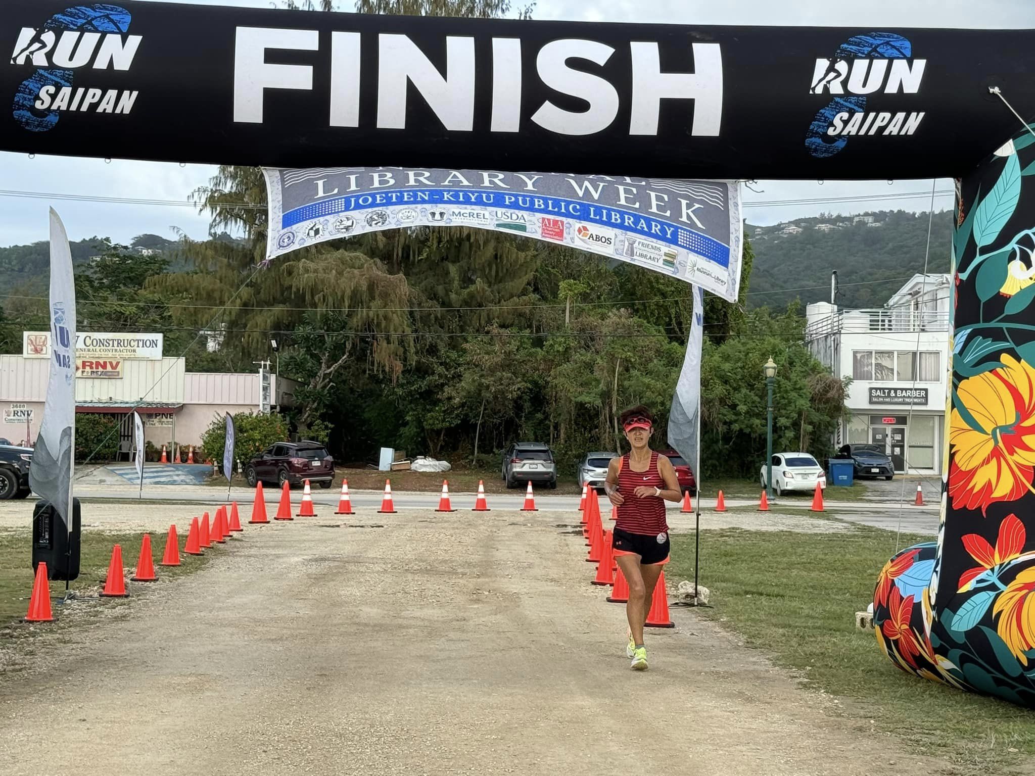 Ann Bang pushes through the finish line in the women's division of the 3rd Annual Friends of the Joeten-Kiyu Public Library 5K Fun Run/Walk at the Garapan Fishing Base on Saturday.