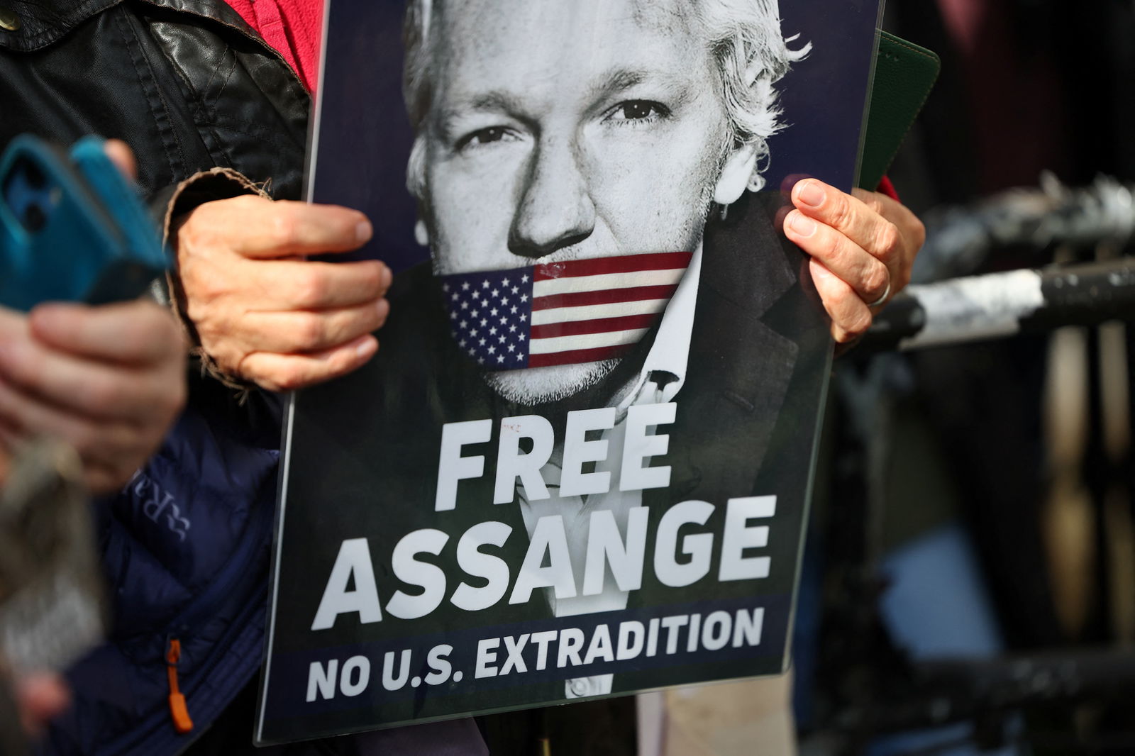 FILE PHOTO: A supporter of WikiLeaks founder Julian Assange holds a sign, on the day the High Court is set to rule on whether Julian Assange can appeal against extradition from Britain to the United States, in London, Britain, March 26, 2024. 