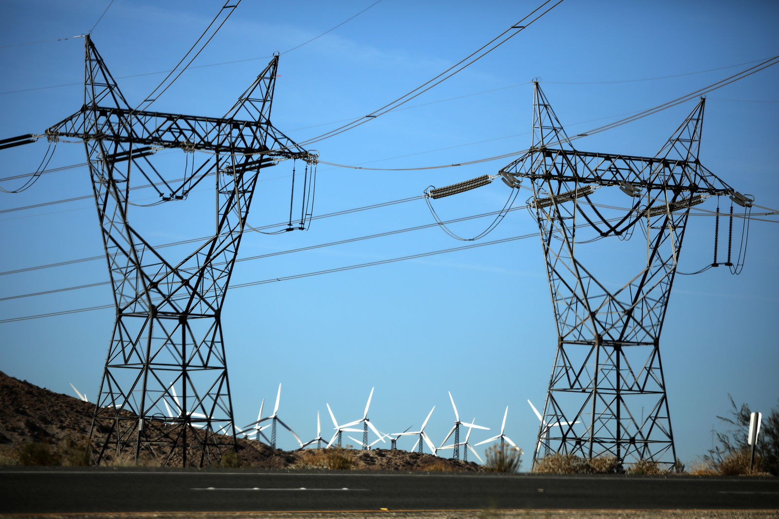 Windmills are seen behind electricity pylons in Palm Springs, California, U.S., November 25, 2017. 