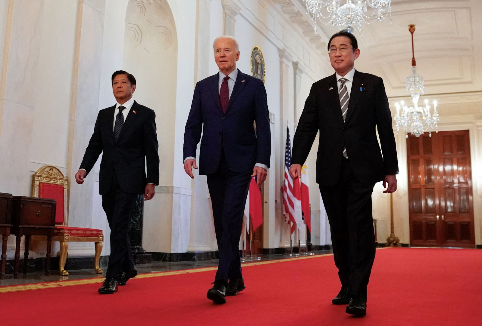 President Joe Biden escorts Philippine President Ferdinand Marcos Jr. and Japan Prime Minister Fumio Kishida to their trilateral summit at the White House in Washington, April 11, 2024.