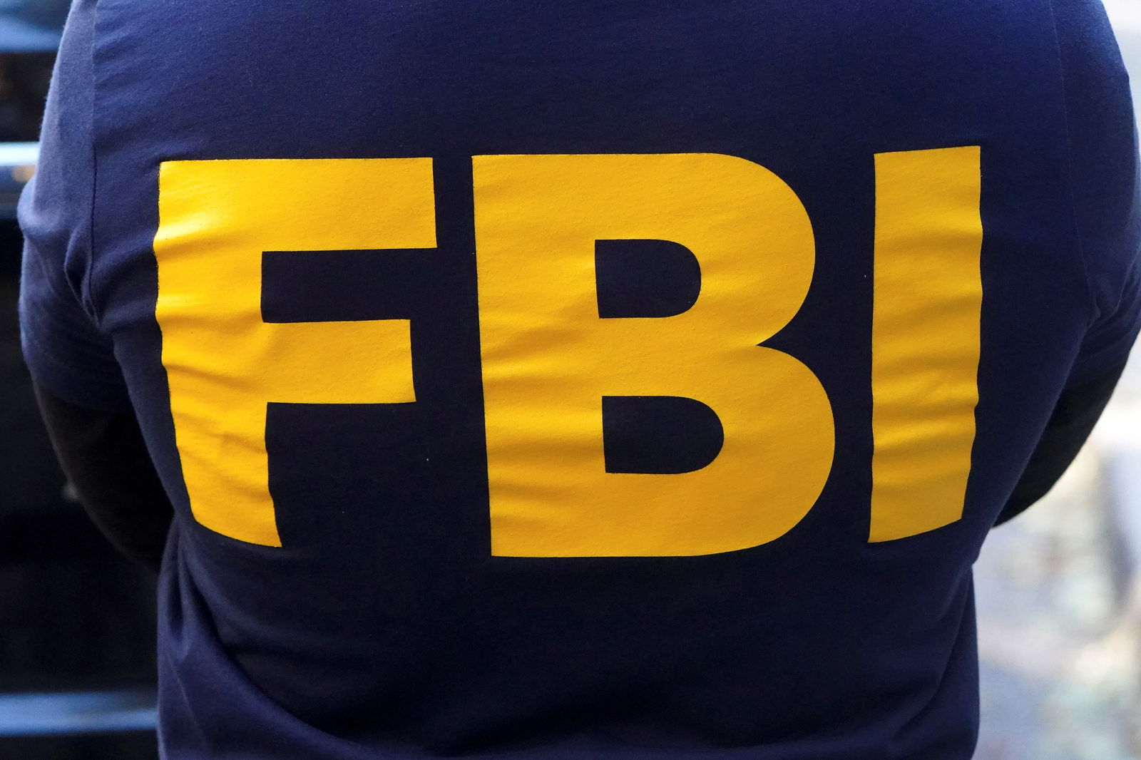 An FBI logo is pictured on an agent's shirt during the U.S. law enforcements raid on Russian oligarch Oleg Deripaska's property in the Manhattan borough of New York City, New York, U.S. October 19, 2021. 