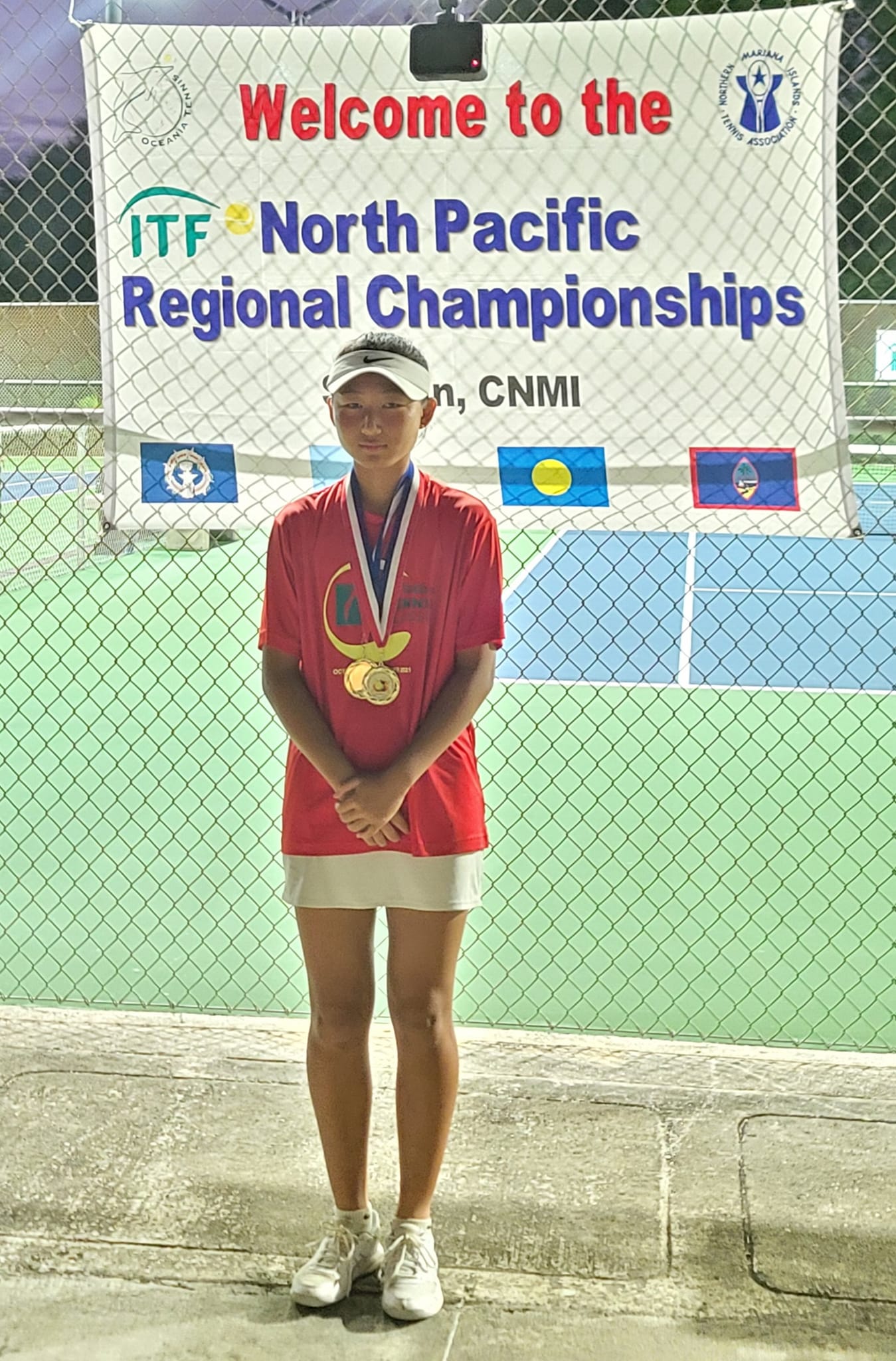 Anne Lee poses for a photo with her two gold medals in the U14 girls singles and doubles events of the 2024 North Pacific Regional Championship, which concluded Saturday at American Memorial Park.