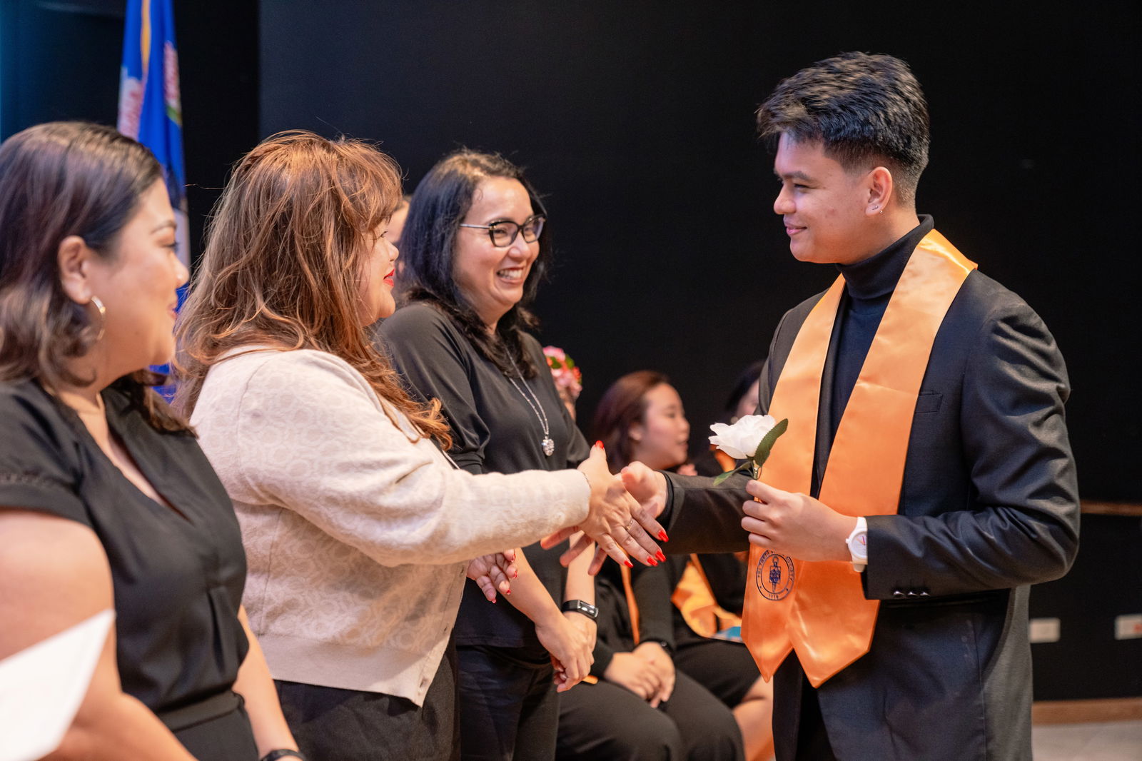 Northern Marianas College student Ejay Aguirre, right, shakes hands with NMC Dean of Student Support Services Charlotte Cepeda at the PTK Honor Society Induction Ceremony held in October 2023.