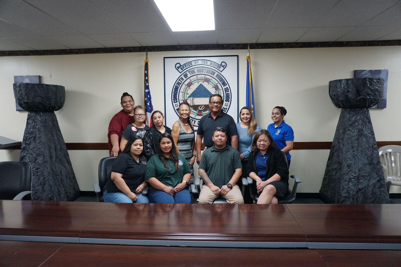 Saipan Mayor RB Camacho and members of the 2024 Liberation Day Committee pose for a photo in the conference room of his office on Tuesday.