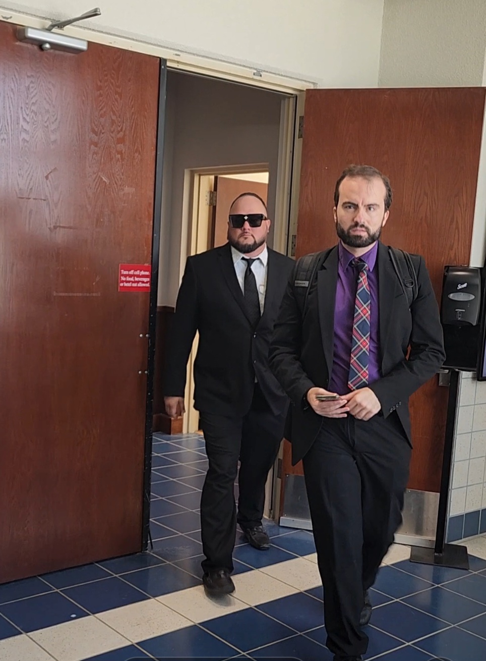 Shayne B. Villanueva, left, comes out of the courtroom on Tuesday with his attorney, Keith Chambers.