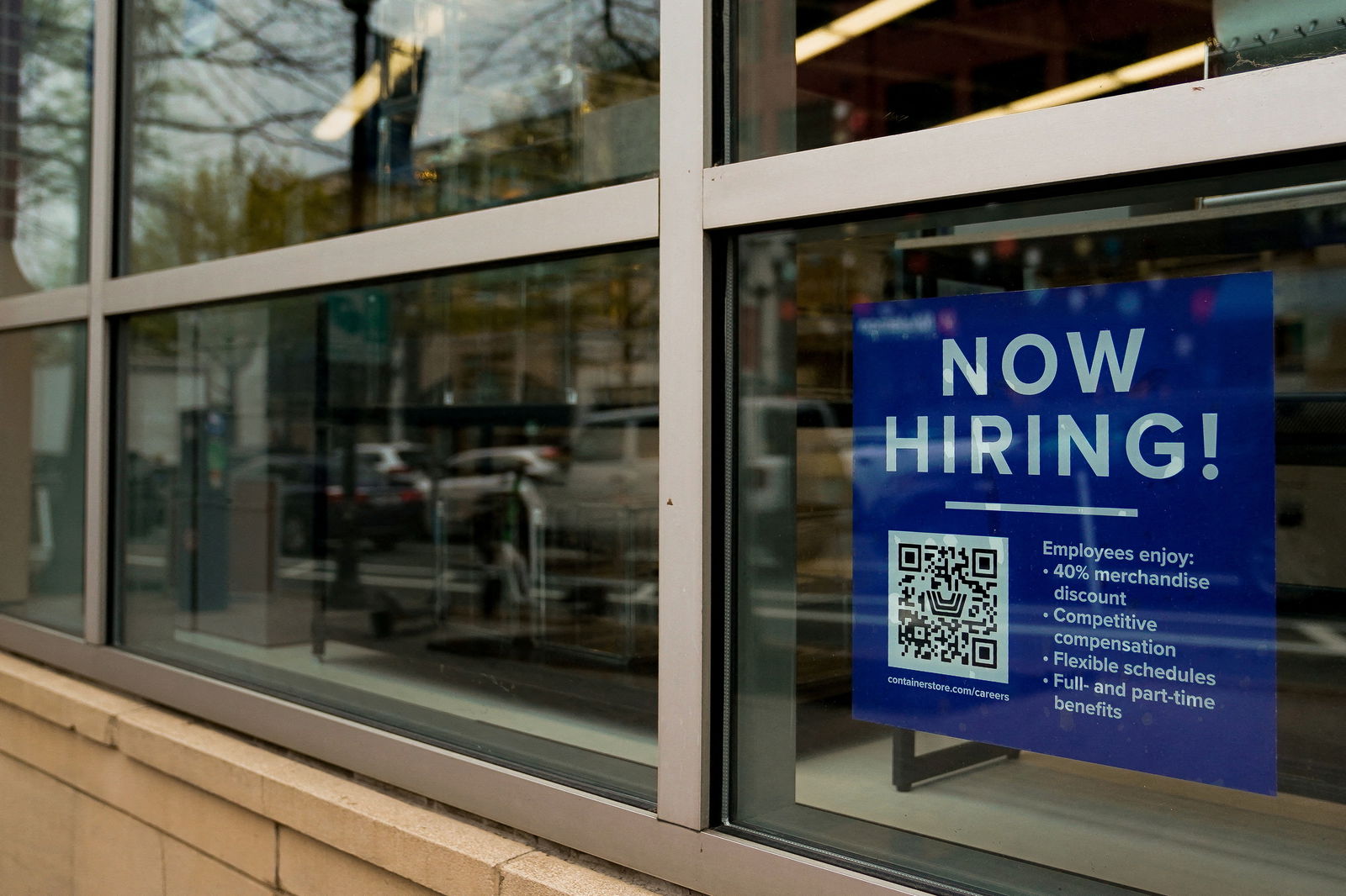 FILE PHOTO: An employee hiring sign with a QR code is seen in a window of a business in Arlington, Virginia, U.S., April 7, 2023. 