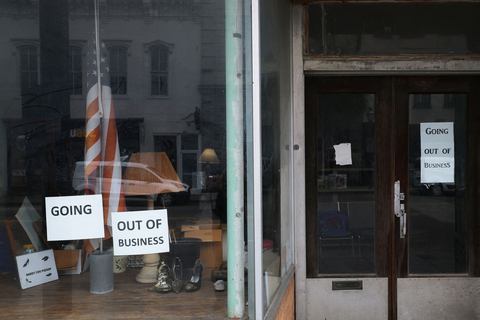 The signs in a storefront window read "Going Out of Business" in Charleston, South Carolina,  March 7, 2024.
