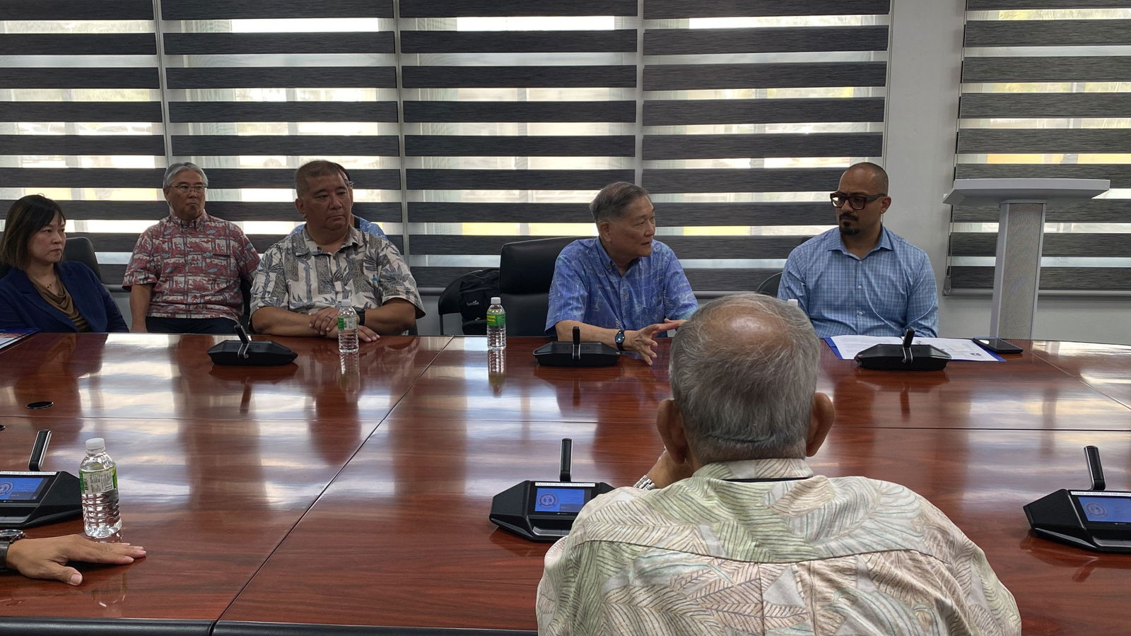 U.S. Department of Agriculture-Rural Development official Chris Kanazawa, 2nd right background, speaks during a ceremonial memorandum of understanding signing ceremony on April 24. With him is Joaquin Altoro, USDA Rural Housing Service administrator.
