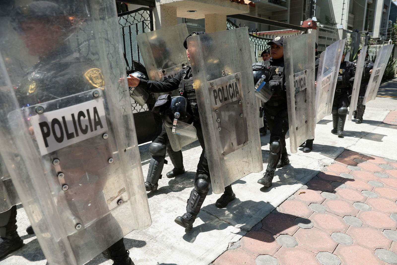 FILE PHOTO: Police officers in riot gear patrol outside the Ecuadorean embassy, after Ecuadorean authorities arrested former Ecuador's Vice President Jorge Glas seizing him from the Mexican embassy and prompting Mexico to suspend bilateral relations, in Mexico City, Mexico, April 6, 2024. 