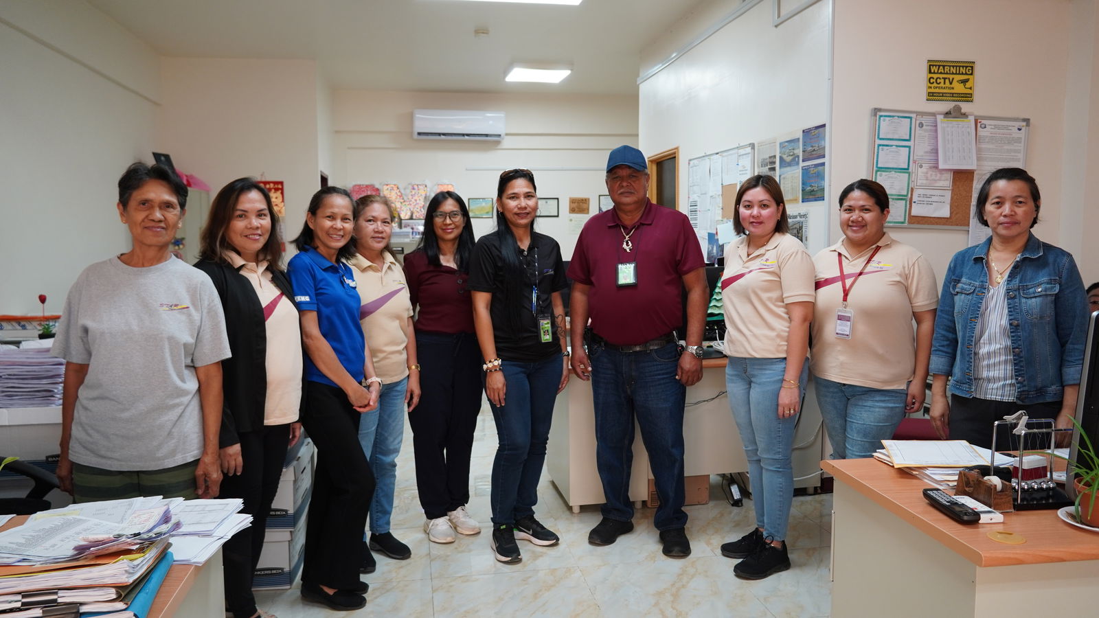 At the center, Donna Cabrera and Jose Cruz with the Accounting team in Tinian. 