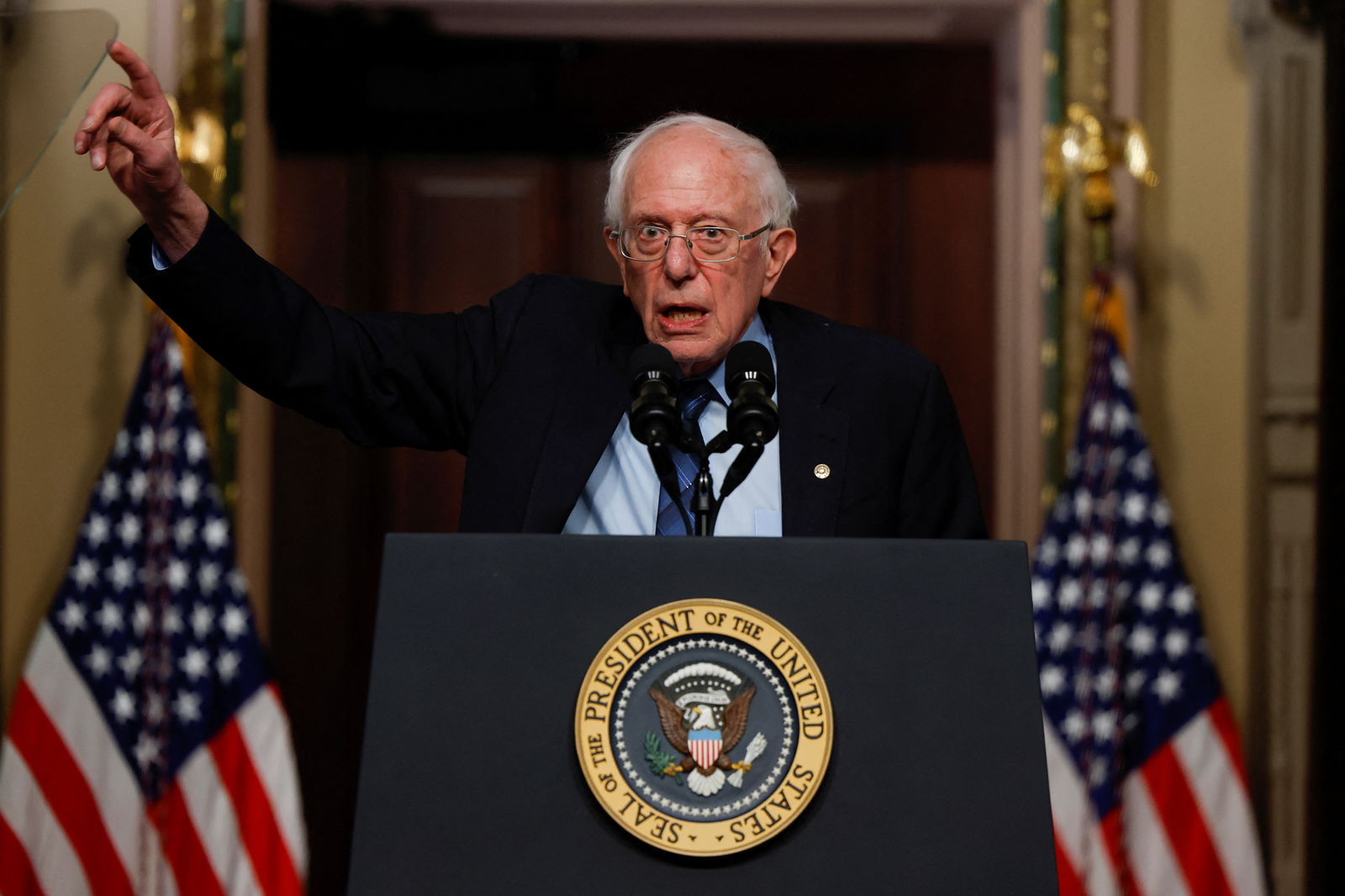 FILE PHOTO: U.S. Senator Bernie Sanders (I-VT) gestures while delivering remarks on lowering healthcare costs, in the Indian Treaty Room of the Eisenhower Executive Office building, at the White House complex in Washington, U.S., April, 3, 2024. 