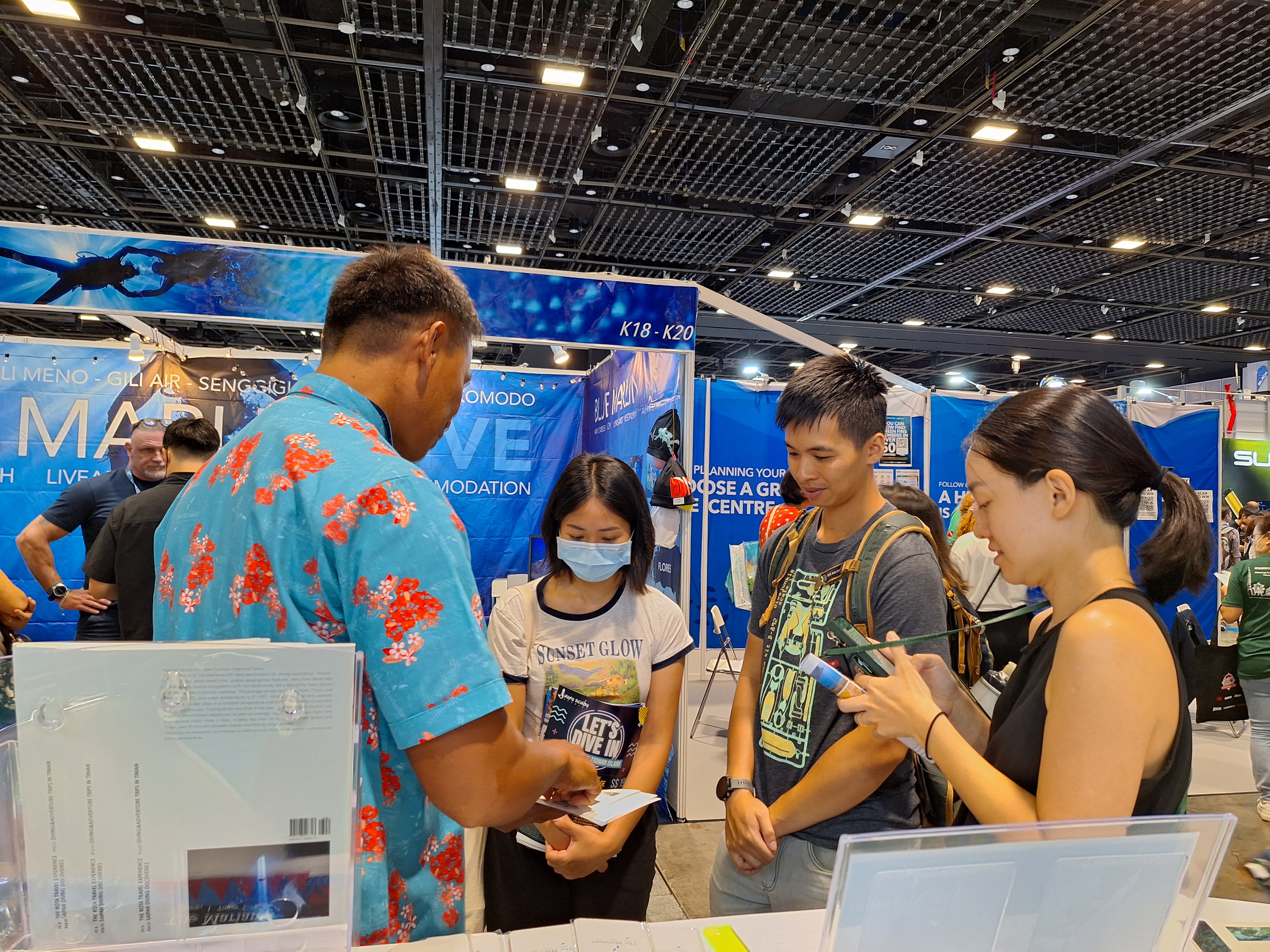 Sydney Takahashi, left, owner of Fishguyz Scuba & Charter joins the Marianas Visitors Authority delegation in promoting the Marianas at ADEX Ocean Festival Singapore on April 12-14, 2024.