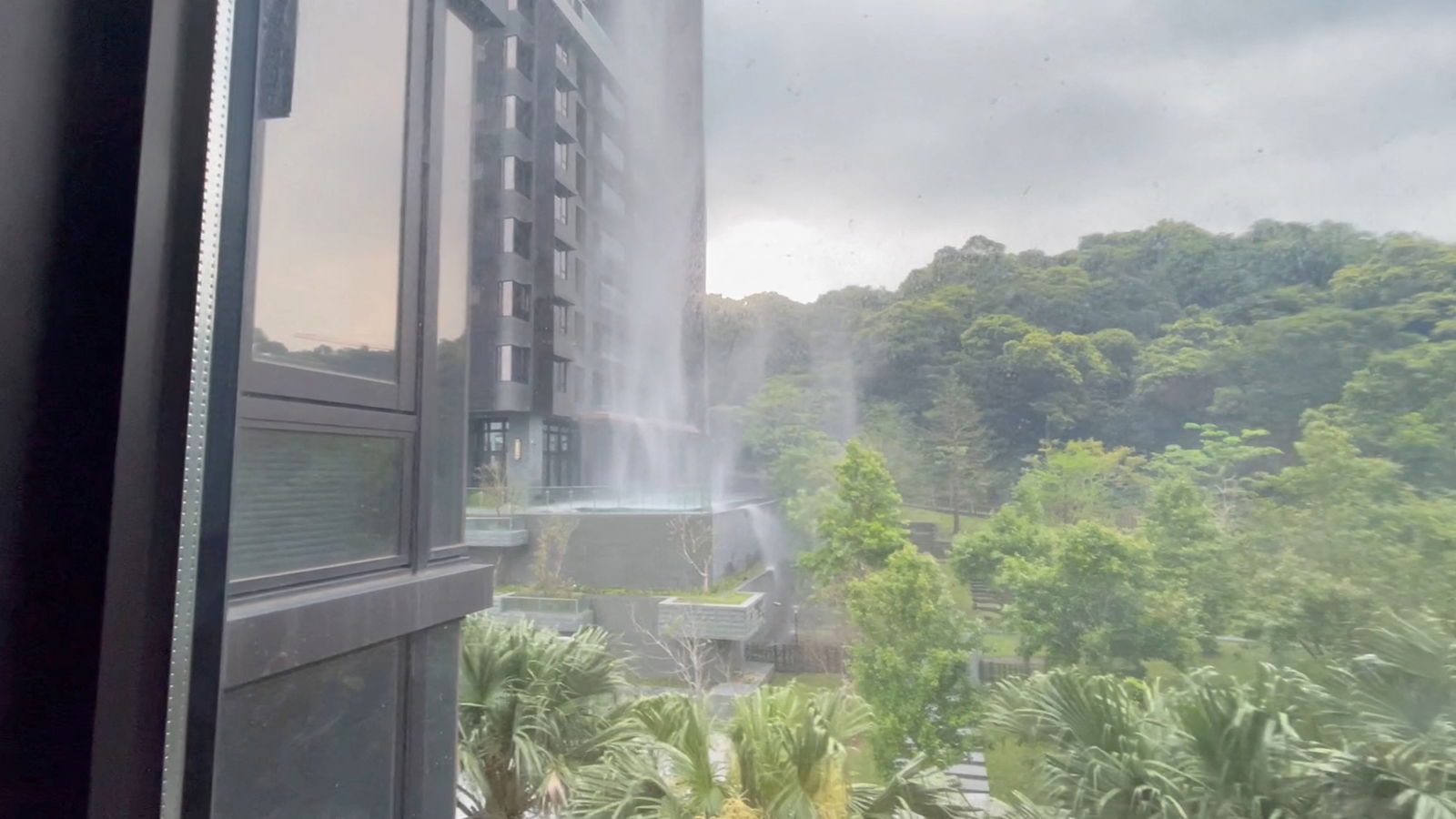 A view from behind a window as debris falls from a building, during an earthquake just off the eastern coast of Taiwan, according to Taiwan's Central Weather Administration, in New Taipei City, Taiwan, April 3, 2024, in this still image obtained from a social media video. 