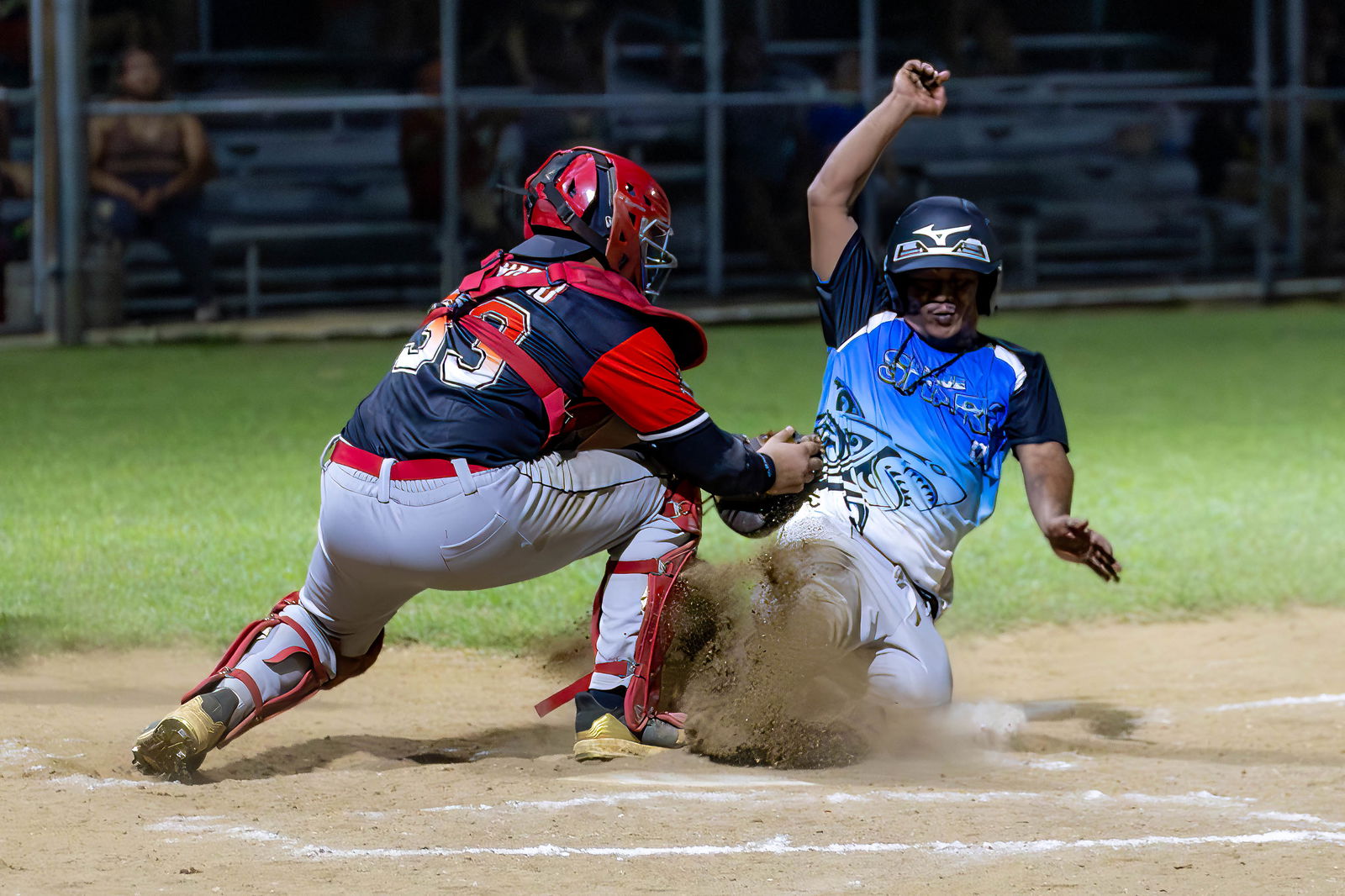 Braves catcher Andrew Camacho, tags out a Blue Sharks runner sliding home during a Tan Holdings Saipan Baseball League game at the Francisco "Tan Ko" Palacios Baseball Field on Tuesday.